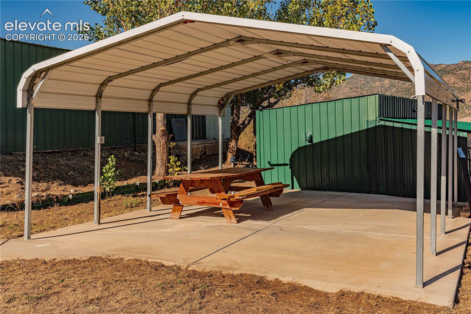 View of parking with a carport