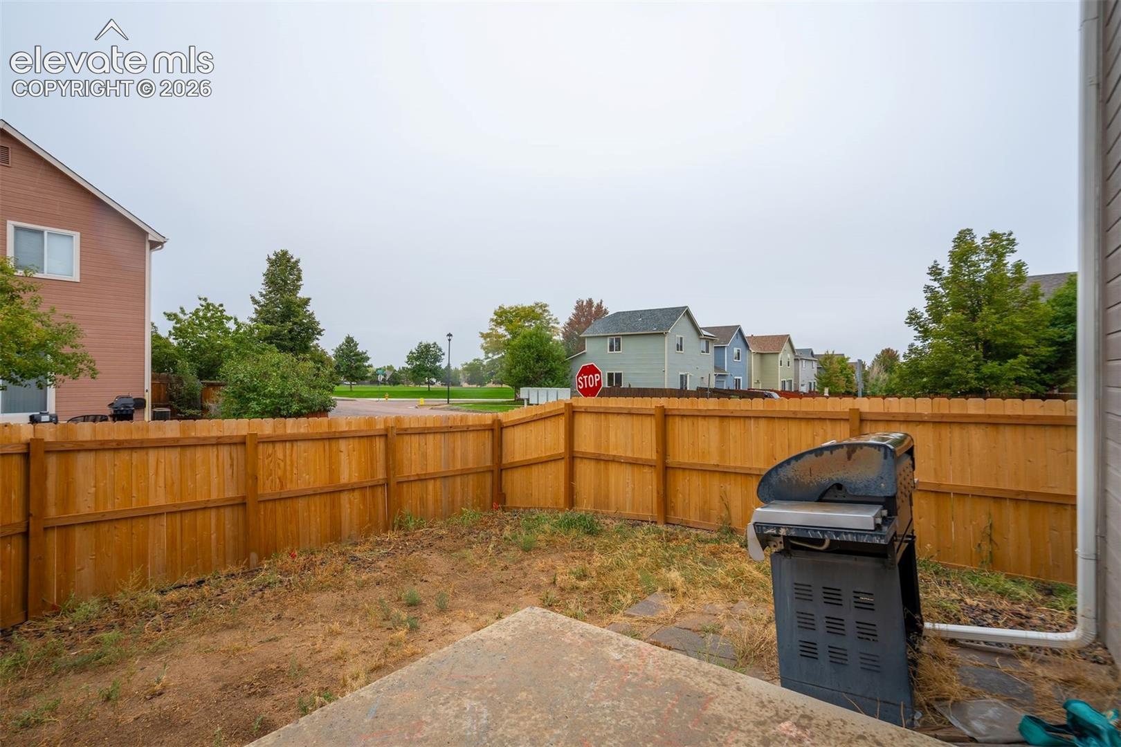 Private backyard featuring a wood privacy fence and a concrete patio