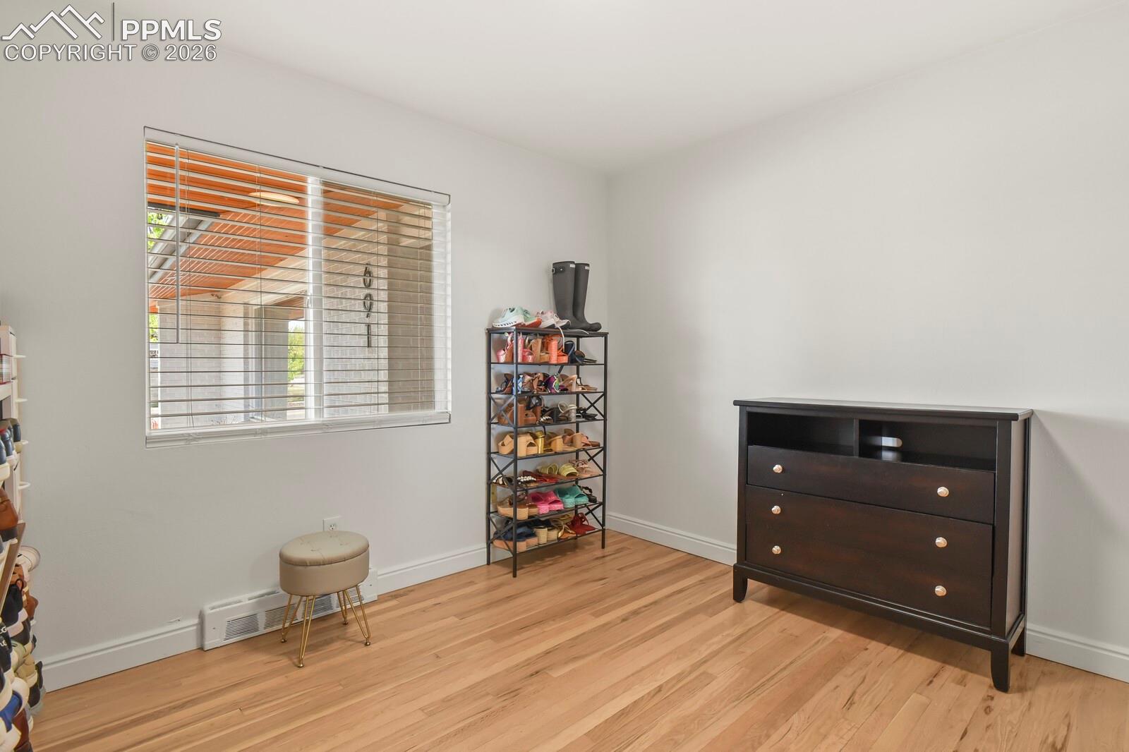2nd bedroom on main level featuring hardwood flooring 