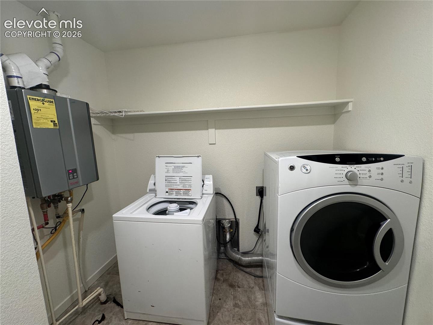 Wall-mounted tankless water heater, built-in shelving, and dedicated utility space