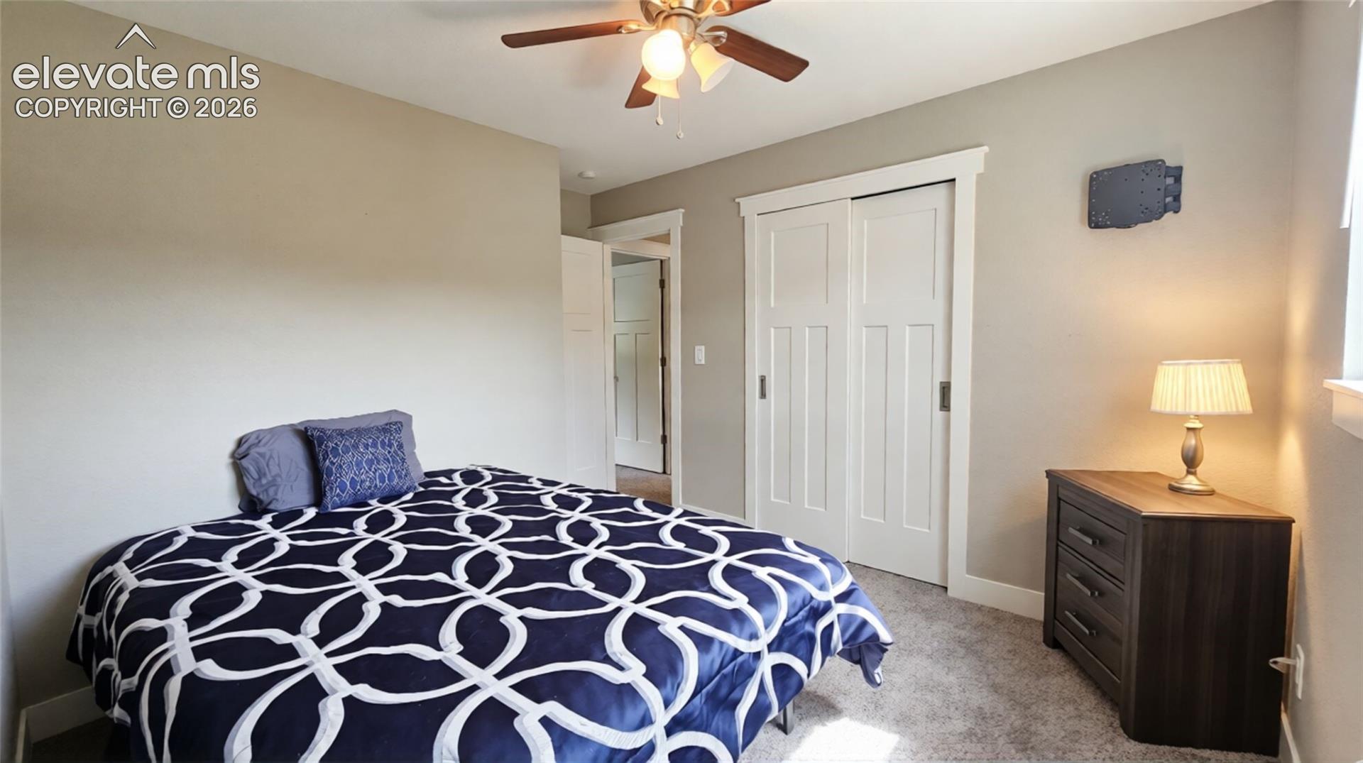 Carpeted flooring and a ceiling fan