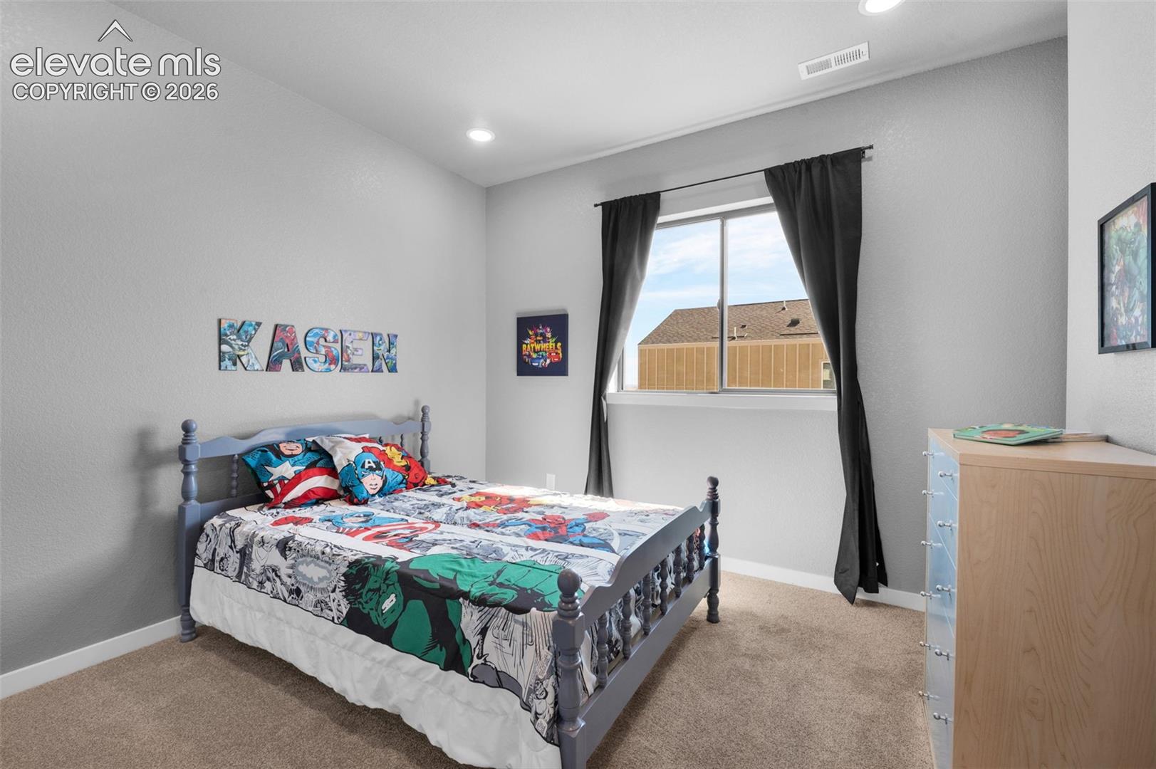 Carpeted flooring, recessed lighting, and a large window with white trim