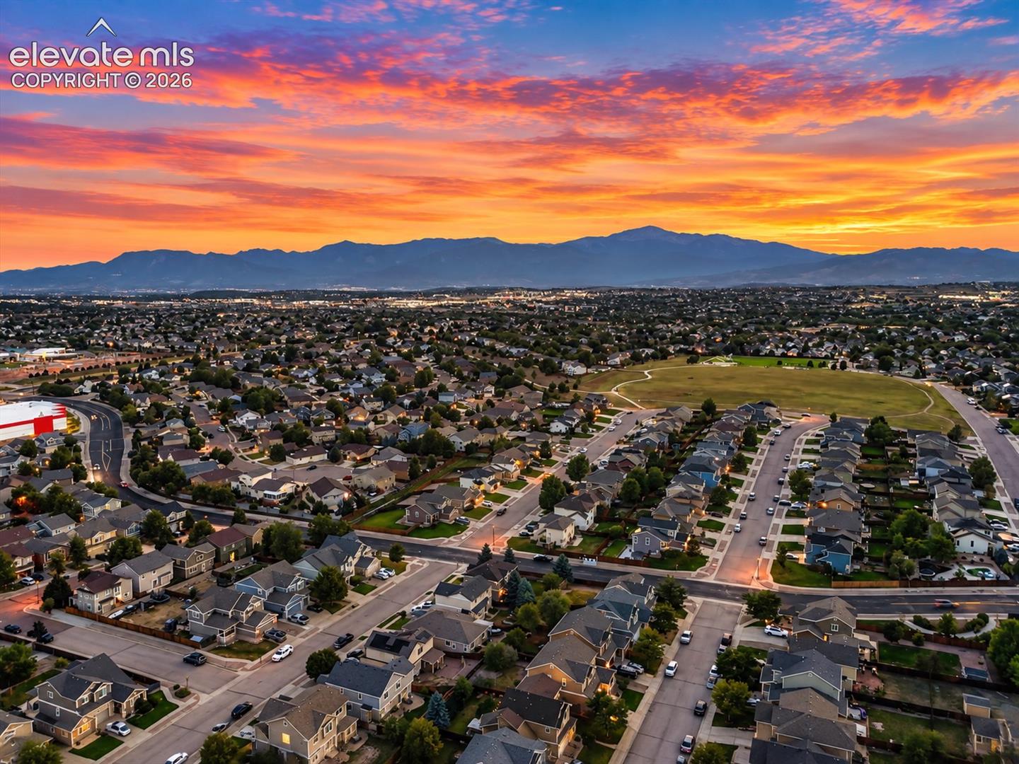 A beautiful aerial perspective showcases the neighborhood setting with Colorado’s Front Range creating a stunning backdrop.