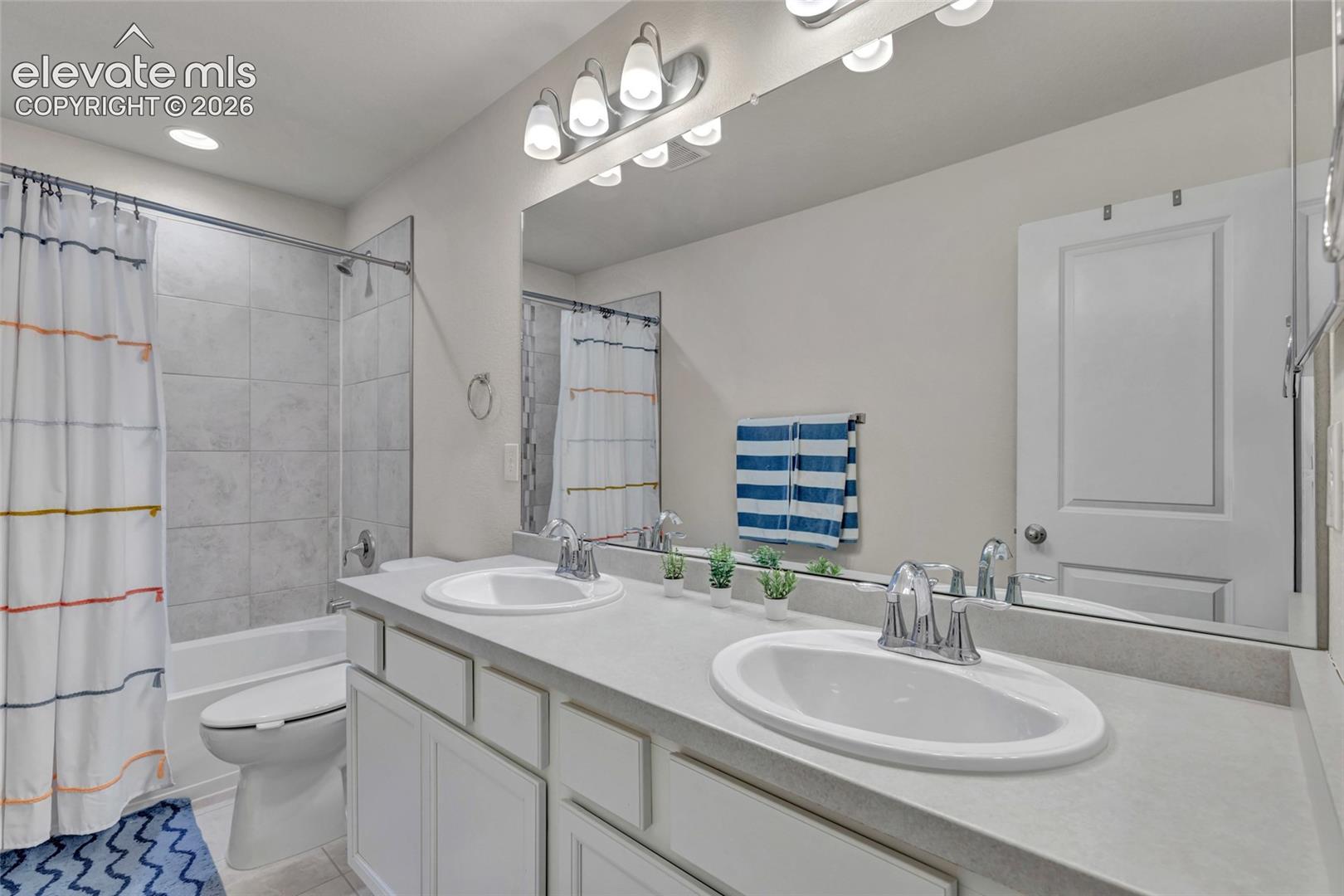 Dual undermount sinks with chrome fixtures, an expansive vanity, and built-in cabinetry