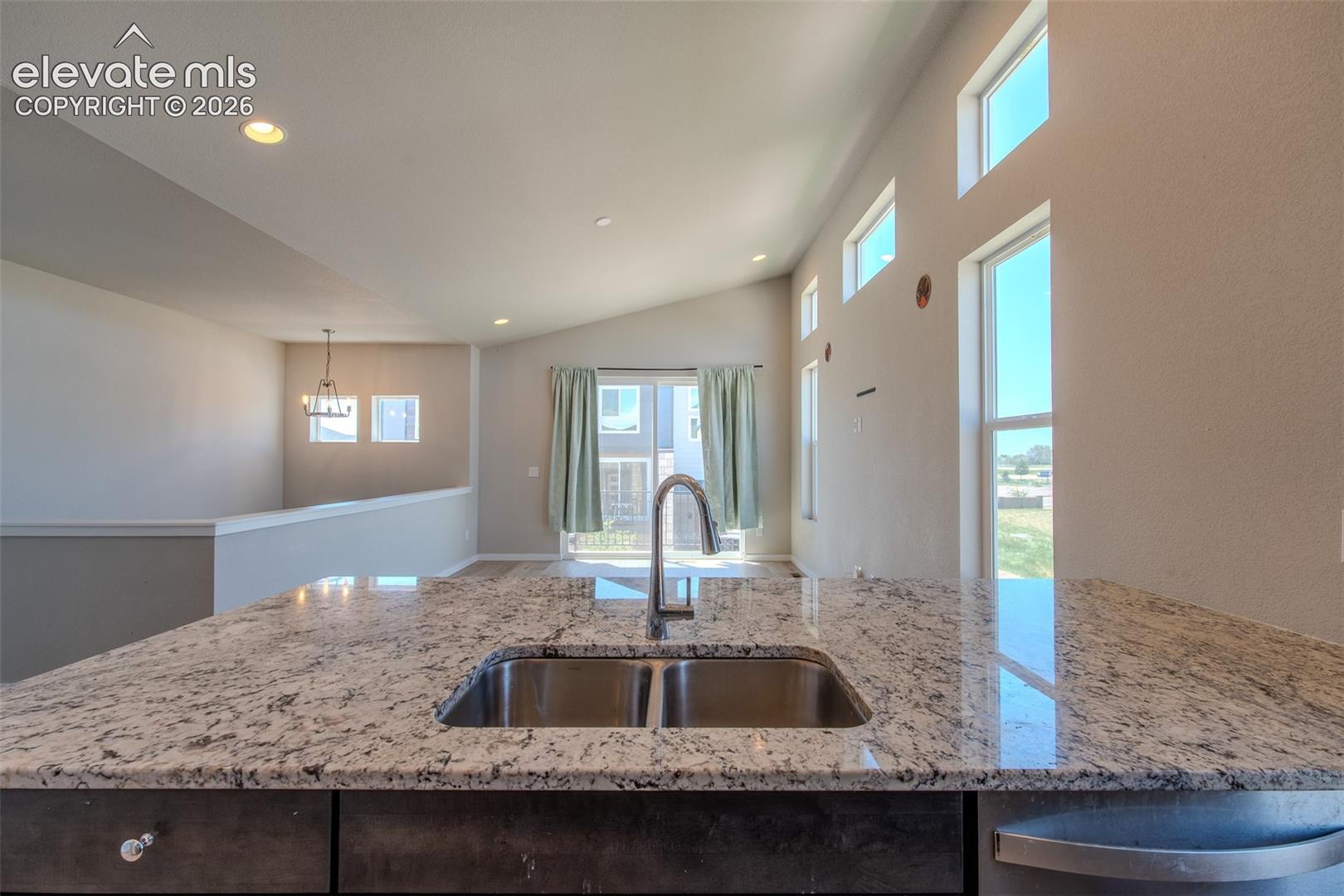Beautiful granite breakfast bar overlooking the Dining Area and Living Room.