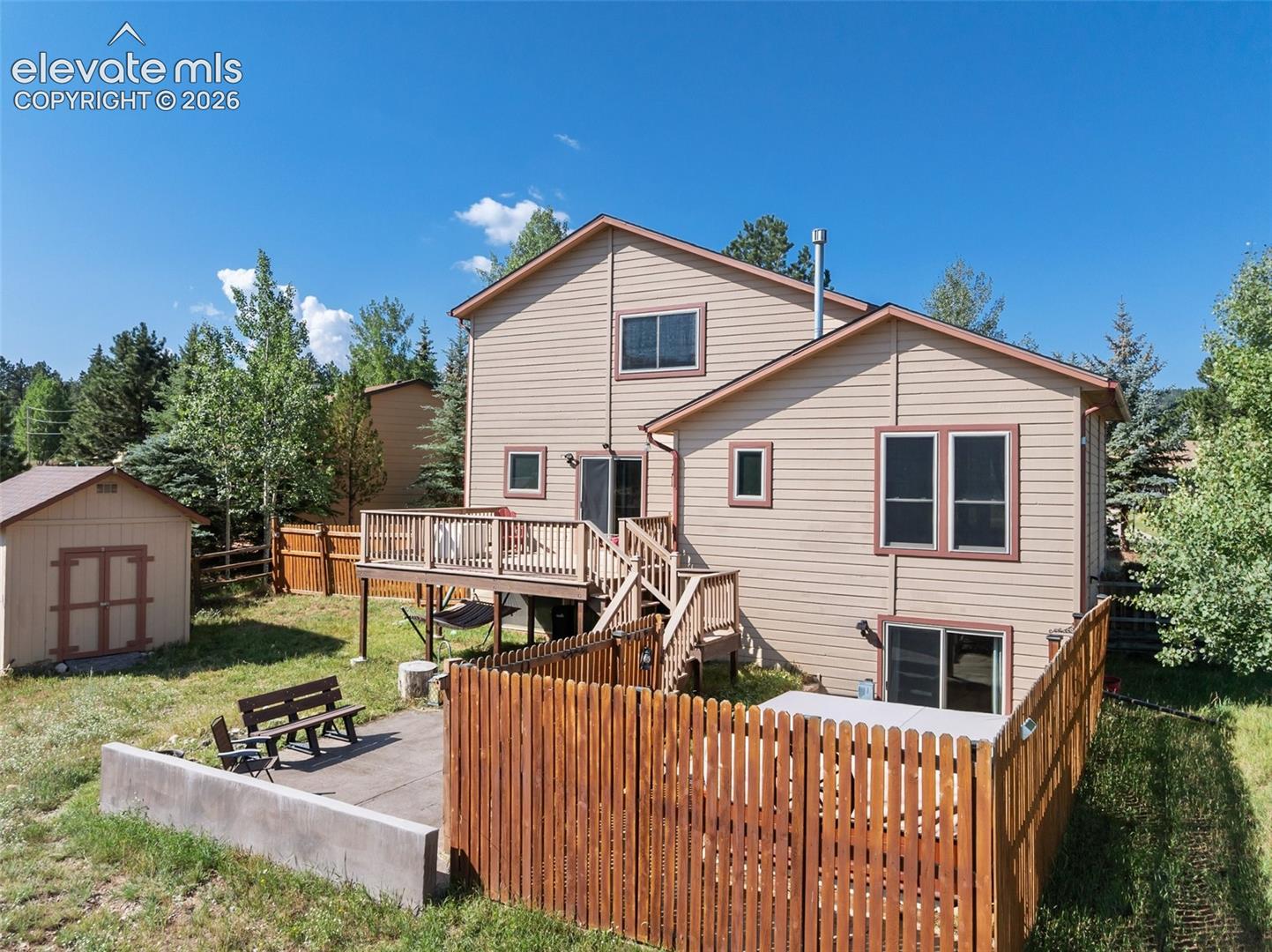 Back pf property with hot tub and privacy fence! 