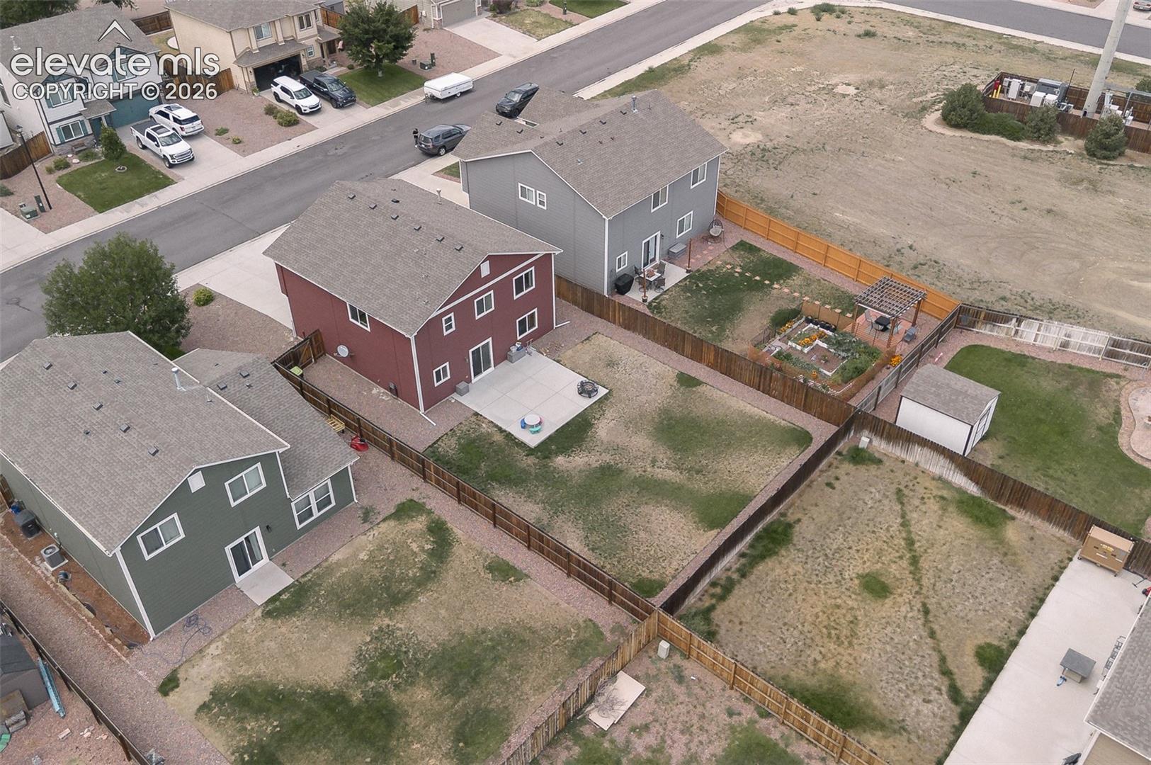 Aerial rear view of home and backyard.