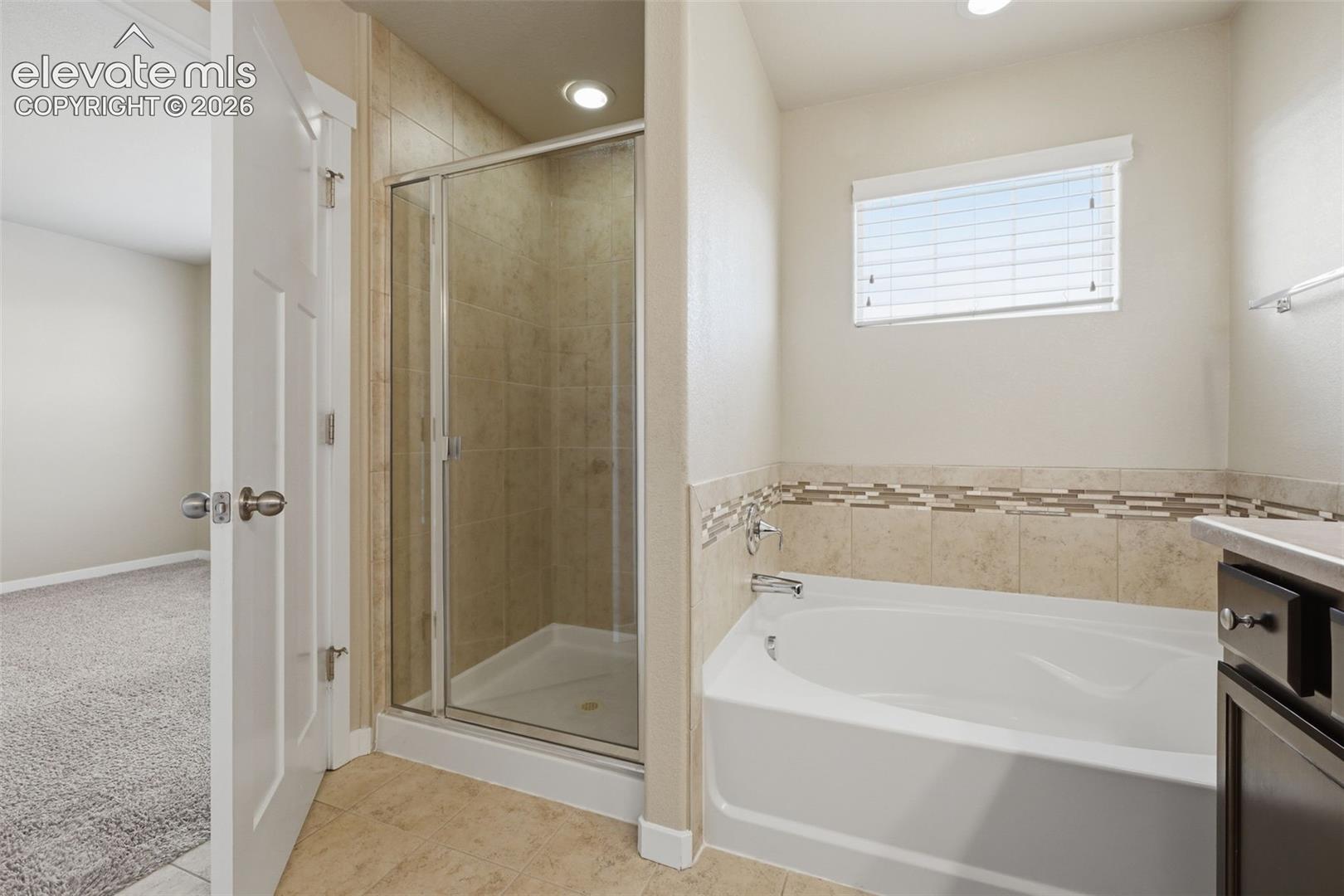 Start or end the day with a soaking tub and separate tiled shower in the primary 5-piece bath.