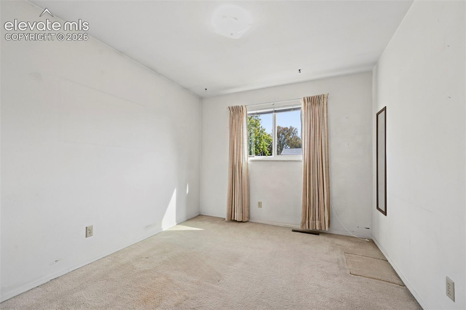 Bedroom 3 with wall-to-wall carpeting, and window