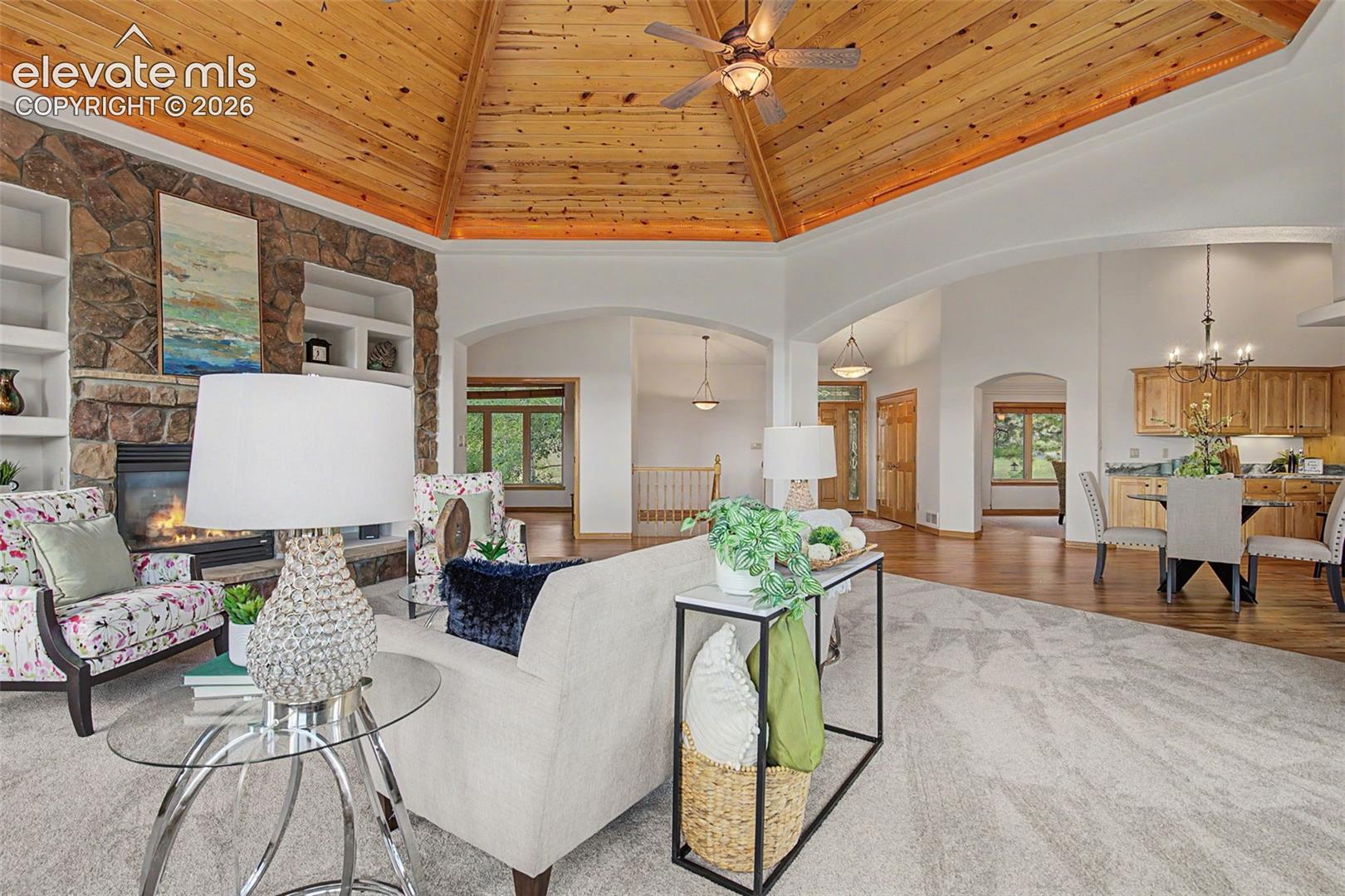 Vaulted wood-paneled ceiling with ceiling fan