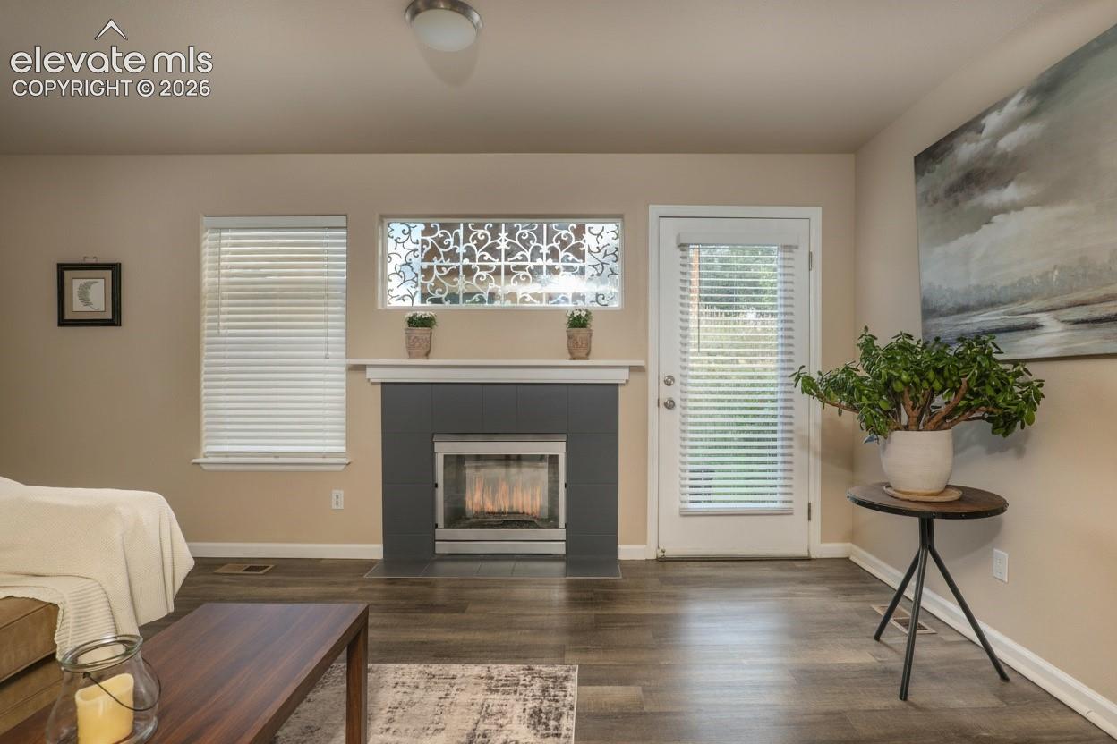 The living room is off of the kitchen. Gas fireplace for the upcoming winter season, LVP flooring and walkout to the quiet back patio.