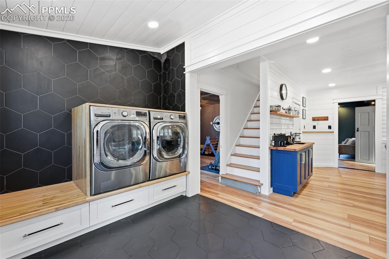 Both the laundry space and pantry offer heated tile floors