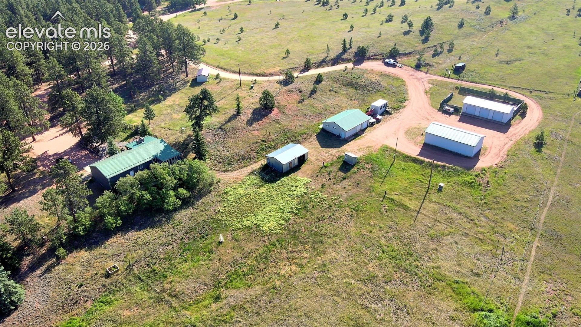 Aerial view of the caretaker's home, shop, barn and garages.