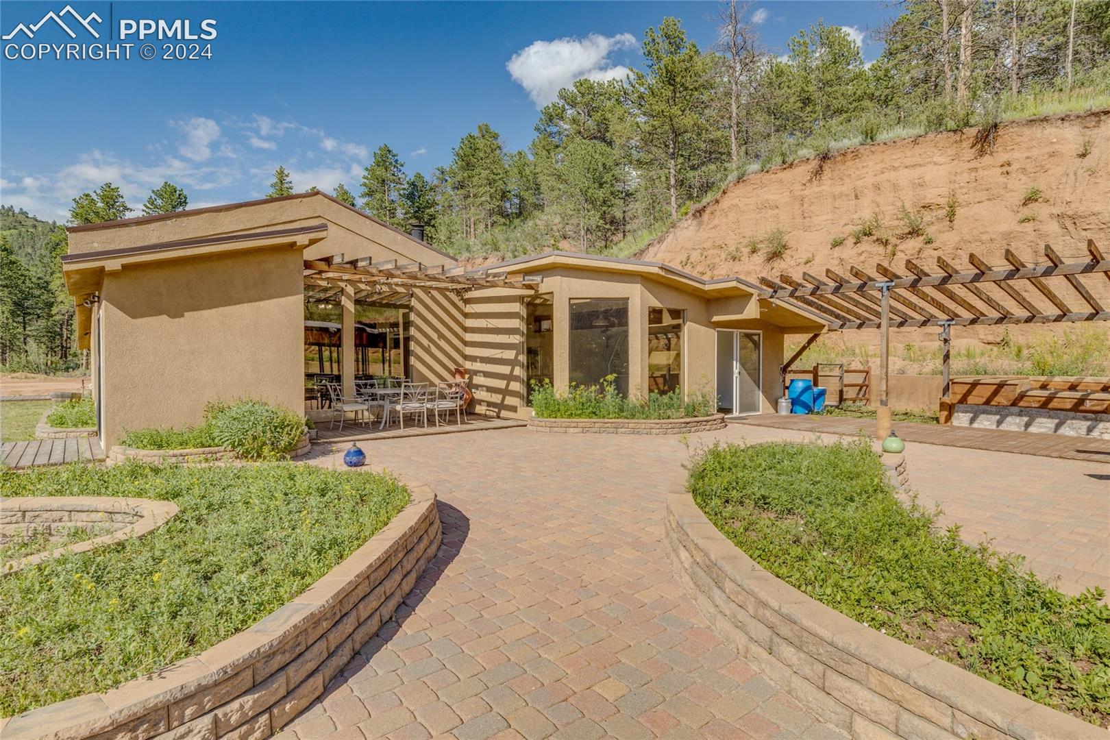 View of front of house with a pergola and a patio