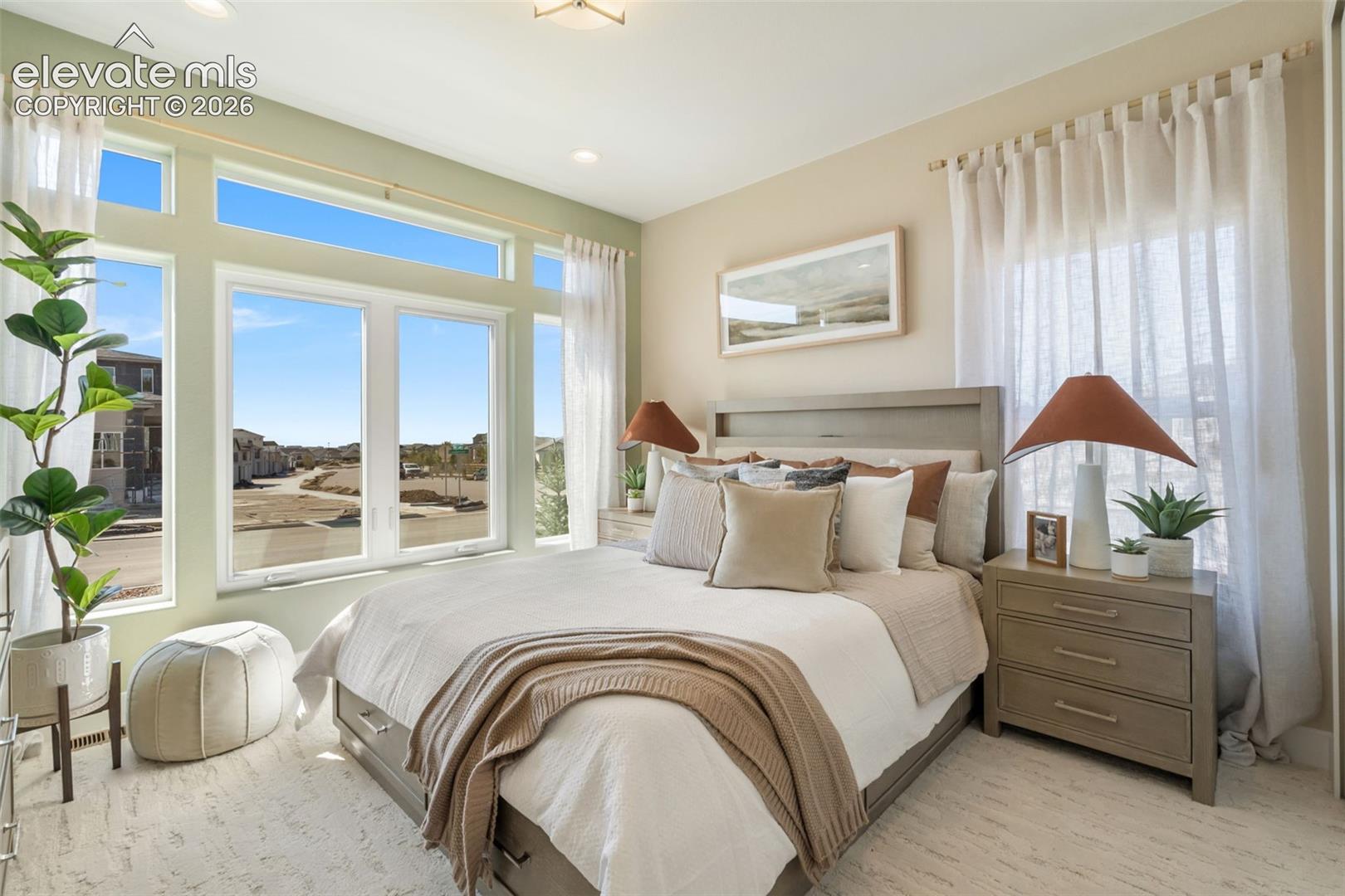 Expansive wall of windows with transom glass, neutral interior paint, and recessed ceiling lighting