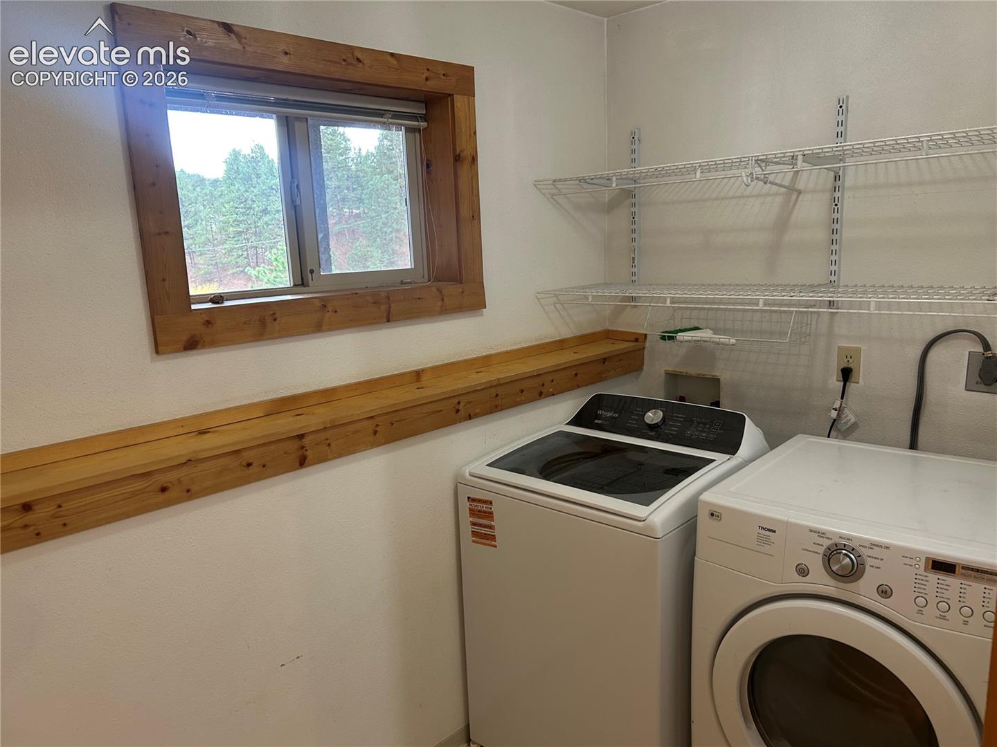 Generously sized laundry room with garden level window for great natural light.