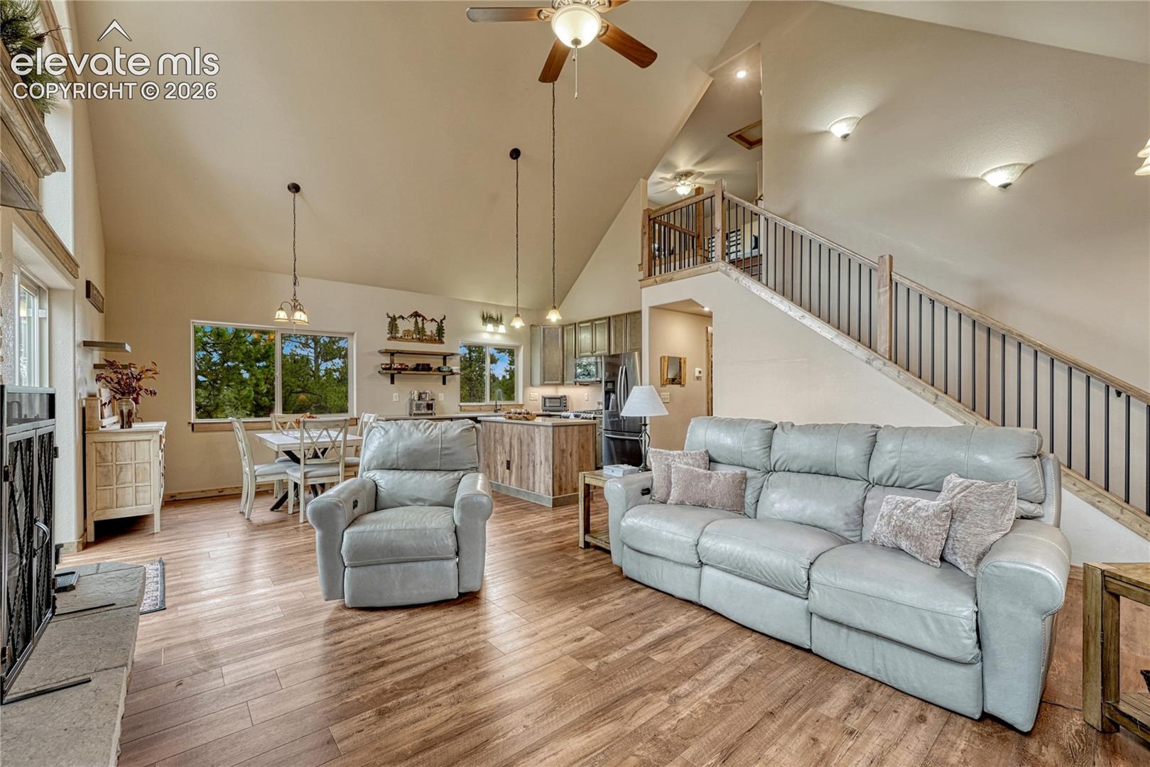 Vaulted ceilings, wood-finish flooring, stone fireplace, custom cabinetry