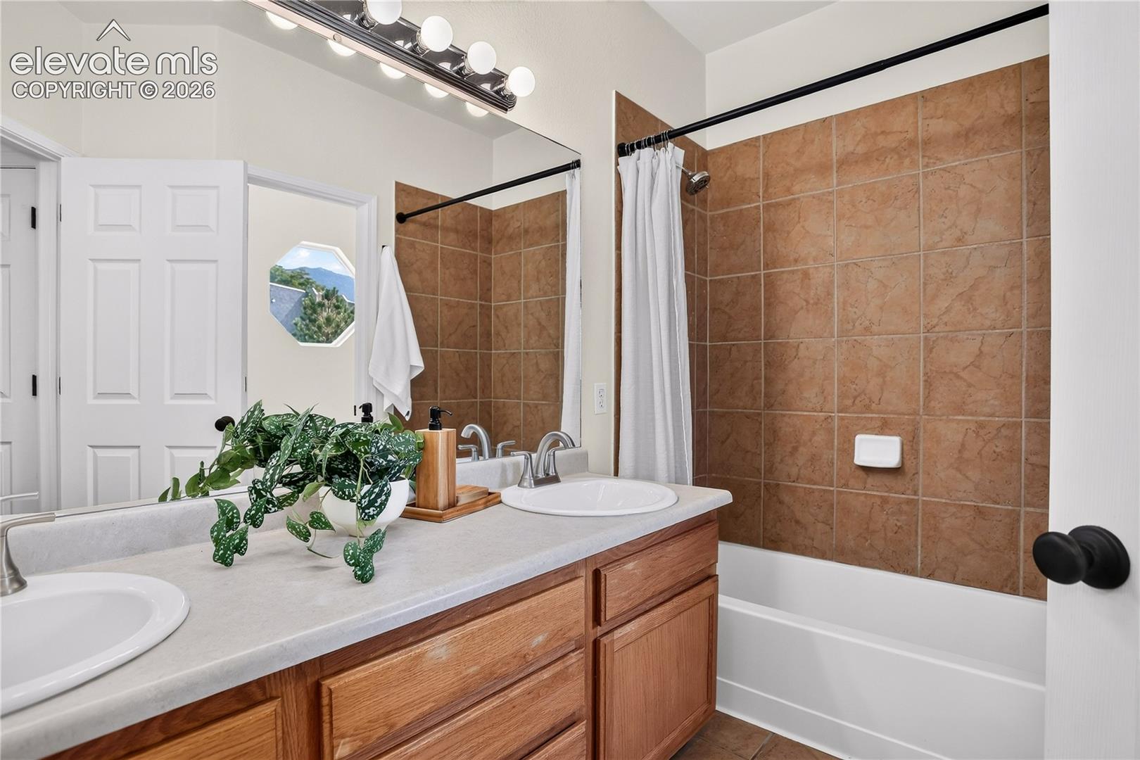 Master bathroom with double vanity and tub/shower. 