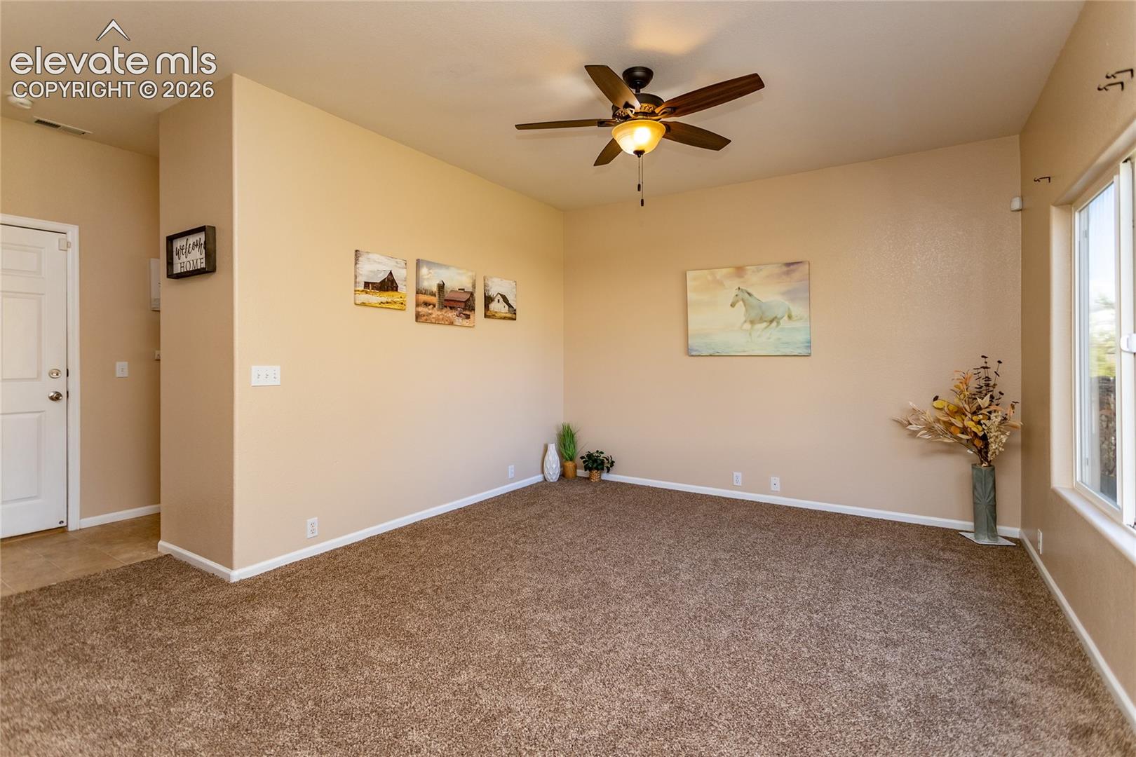 With brand-new carpeting and a ceiling fan, this large family room is perfect for casual living and entertainment