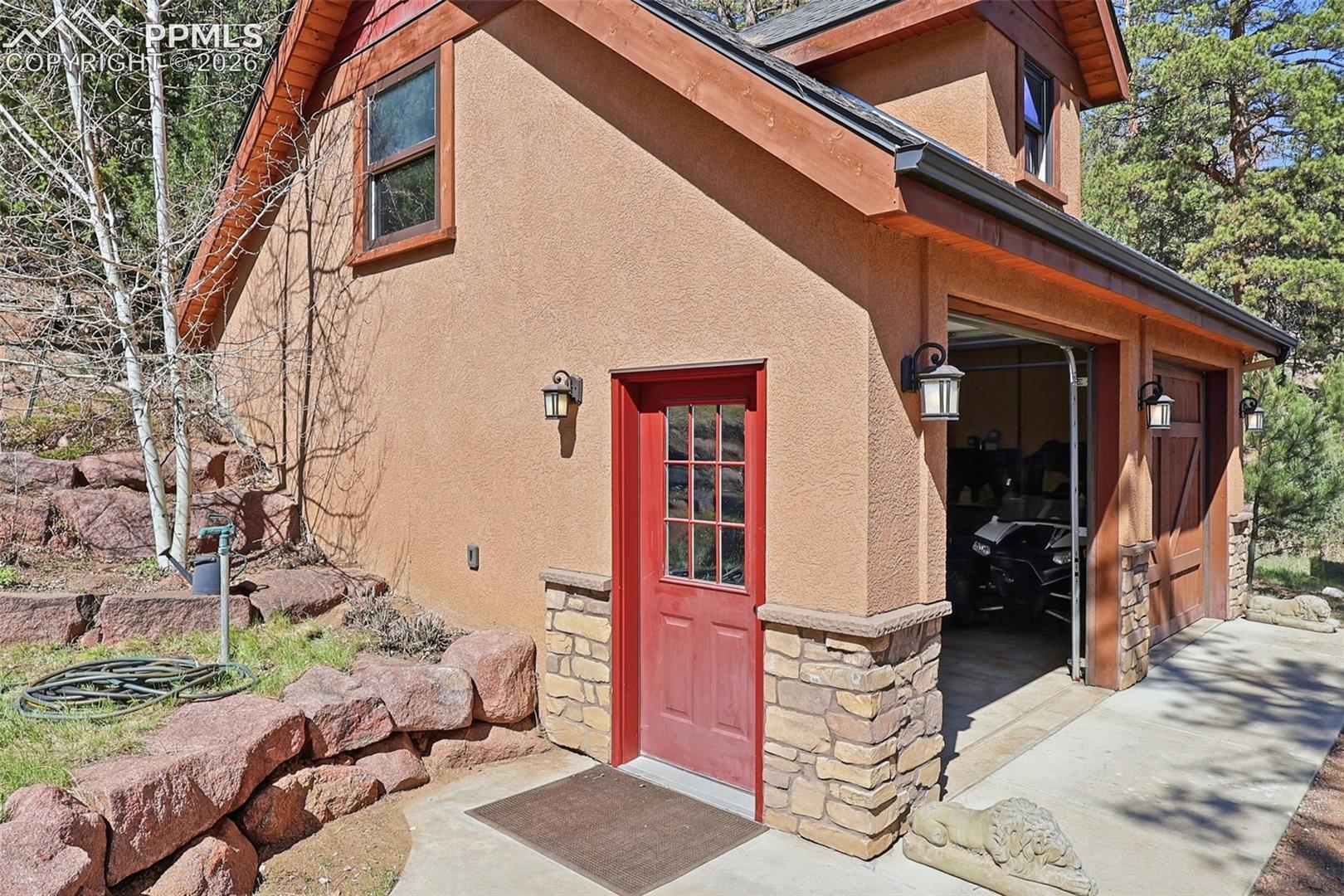 The 2 1/2 car detached garage perfectly reflects the homes design and structual elgance.  