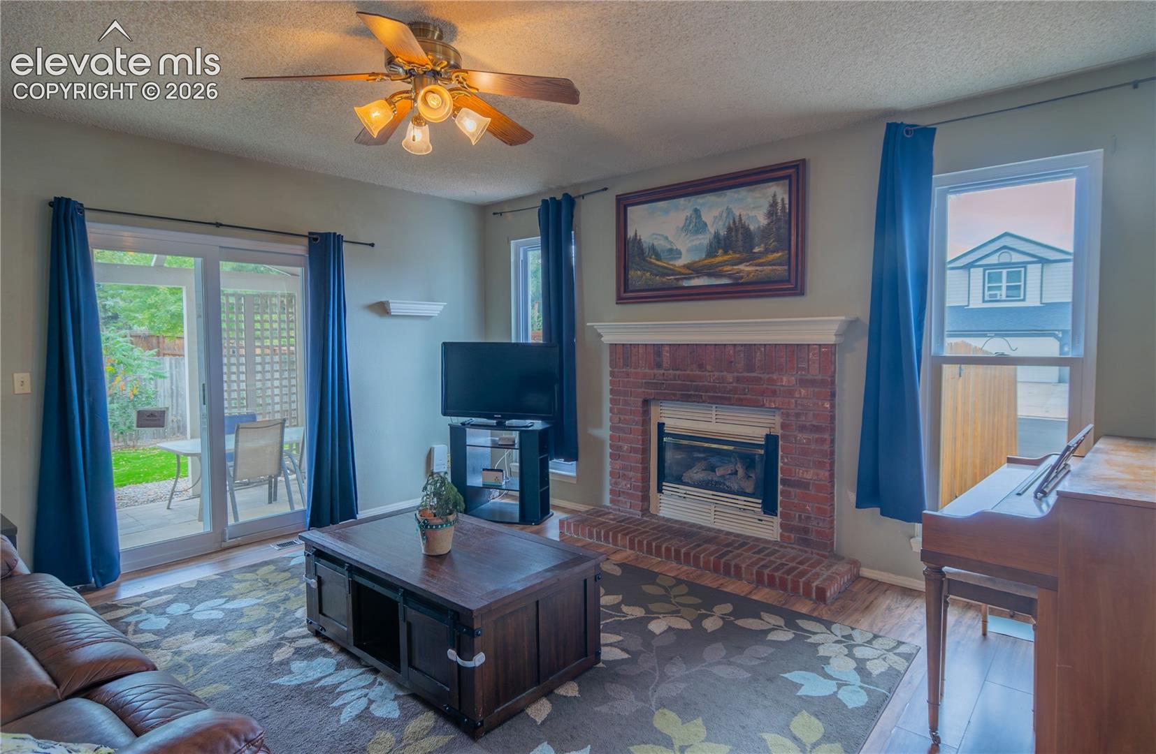 Brick fireplace with a gas insert and a white mantel