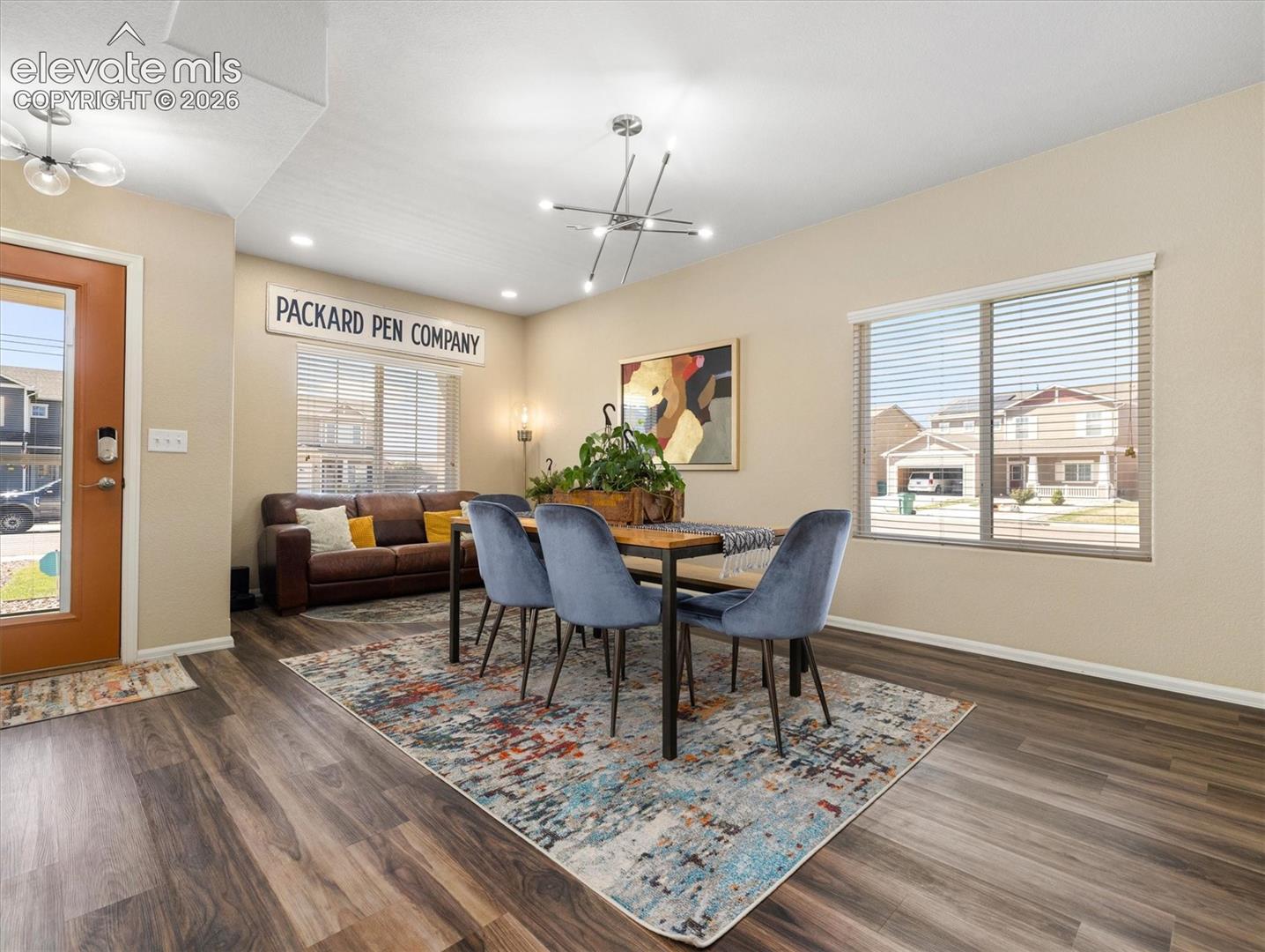LVP Wood-look flooring throughout, complemented by recessed lighting and a modern chandelier