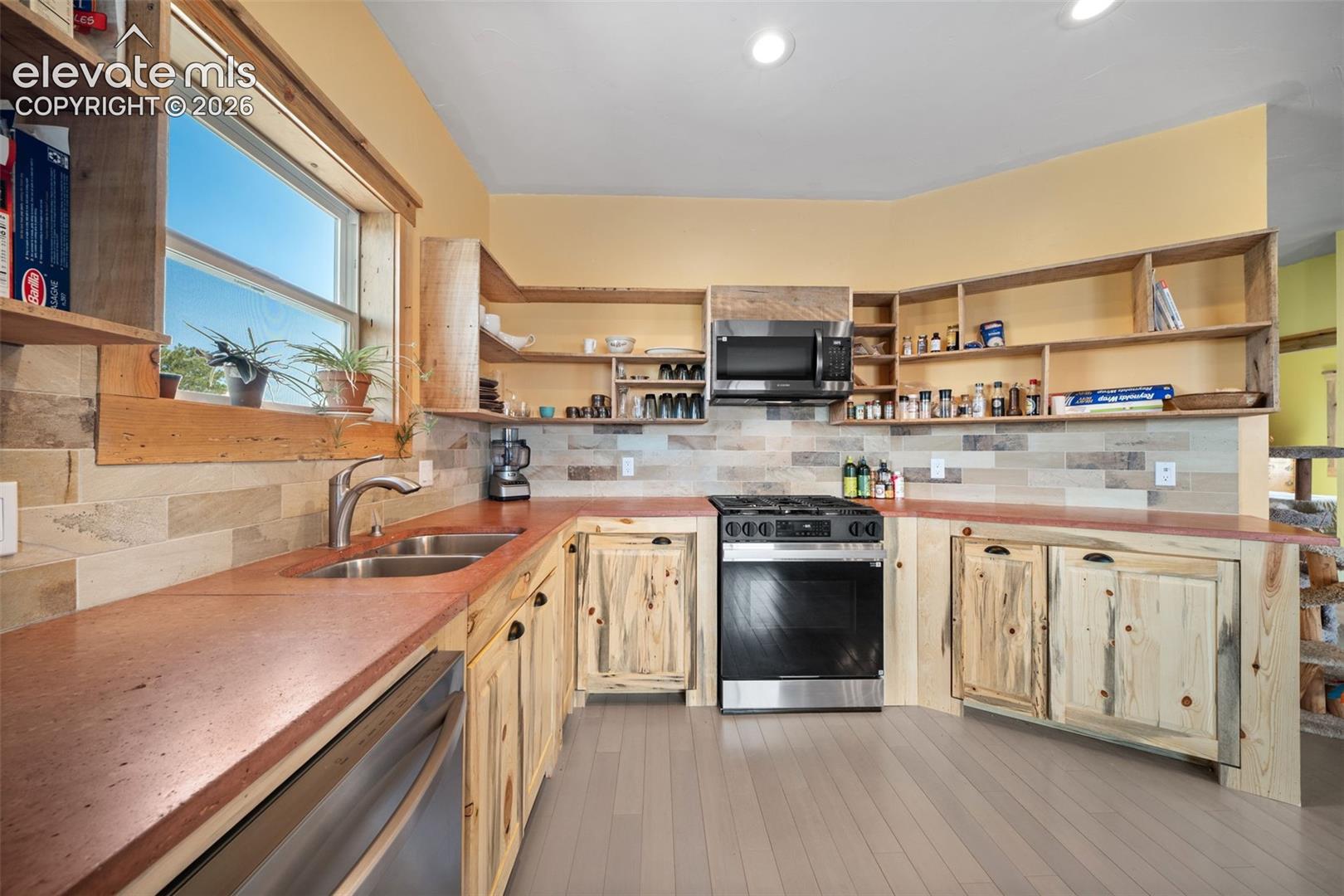 custom Bettkill pine cabinetry and fossil tile accents.