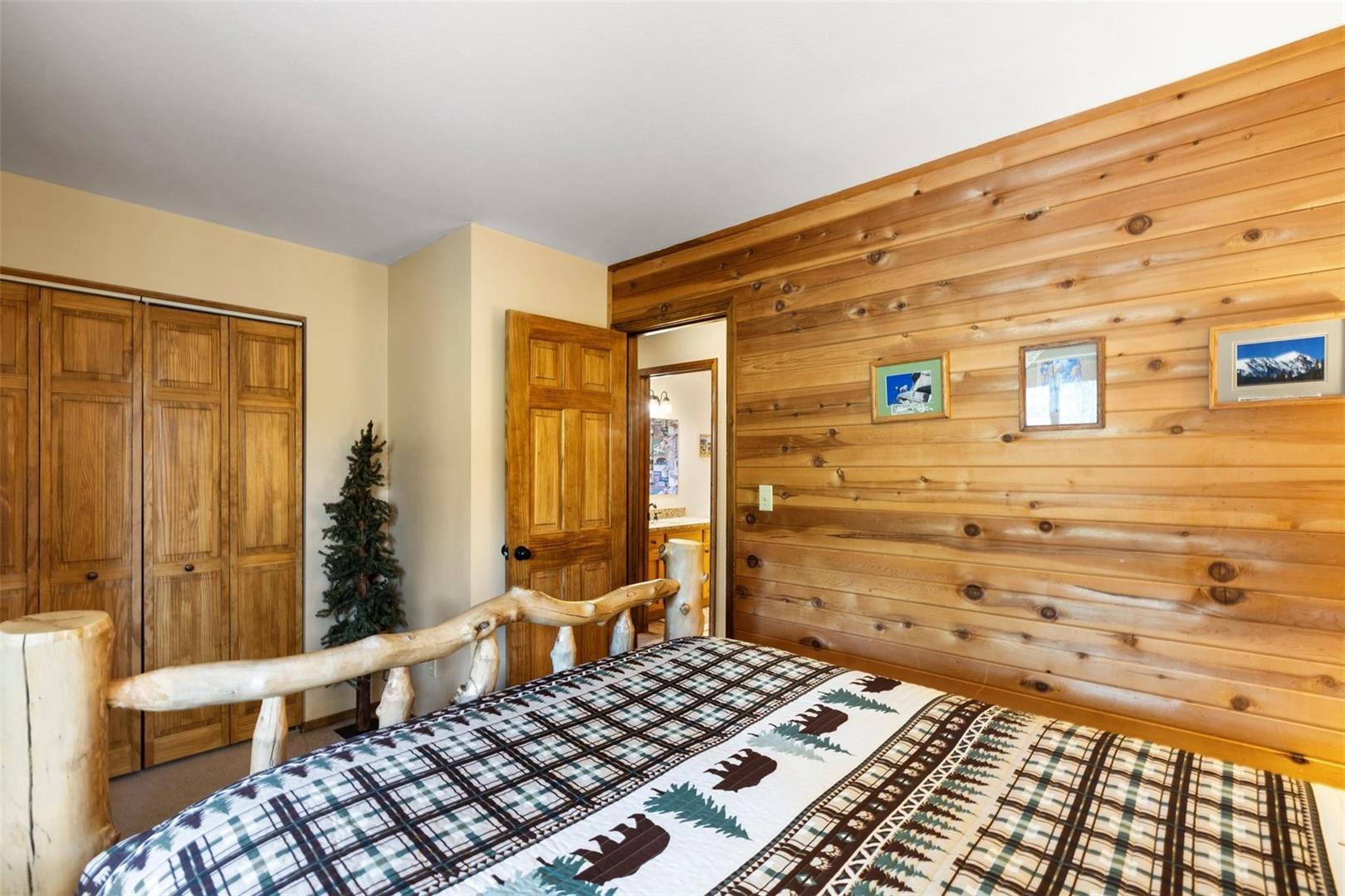 Wood-paneled accent wall, wood-finish bi-fold closet doors, and a wood-finish interior door