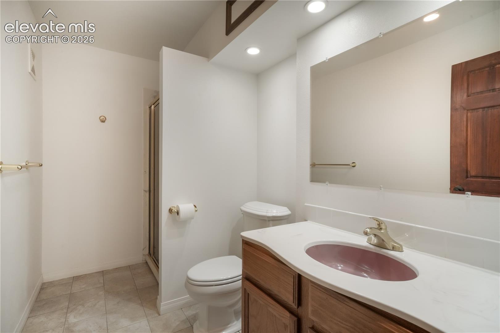 Basement 3/4 bathroom with tile flooring