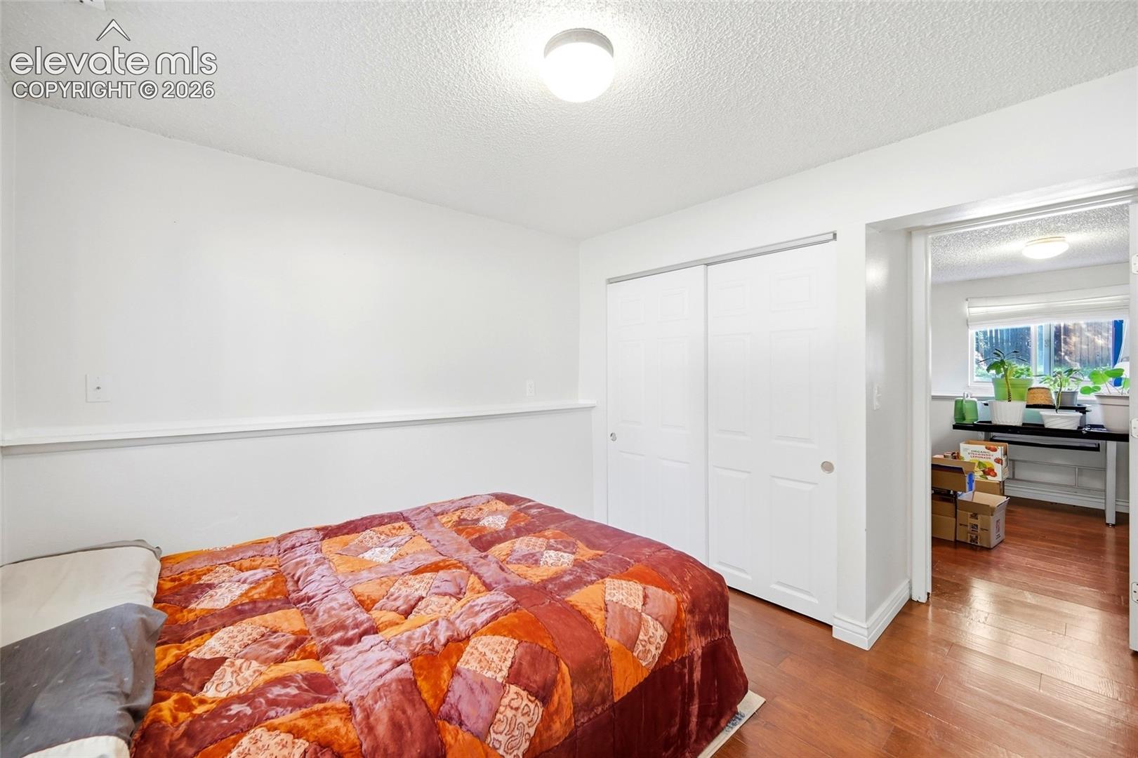 Lower level bedroom with wood flooring