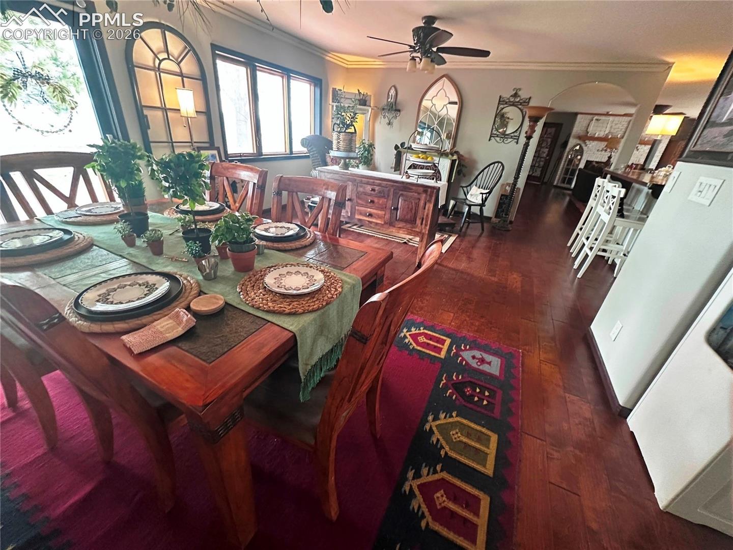 Shows Dining room, sitting/reading room and counter dining area adjoining kitchen. Wood floors and sliding door to backyard.