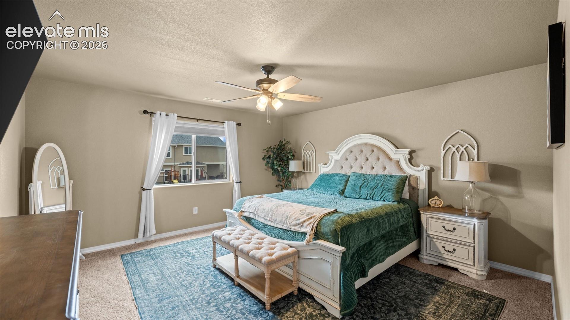 Spacious room featuring carpeting, neutral-toned walls, and a ceiling fan with integrated lighting