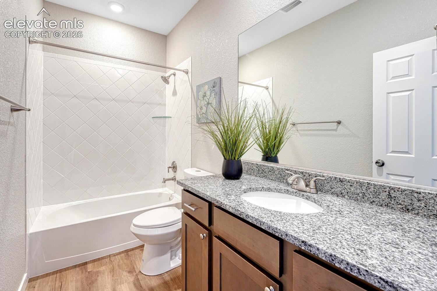 A full bathroom serves the secondary bedrooms. Your choice of finishes with undermount sink and tiled shower tub.