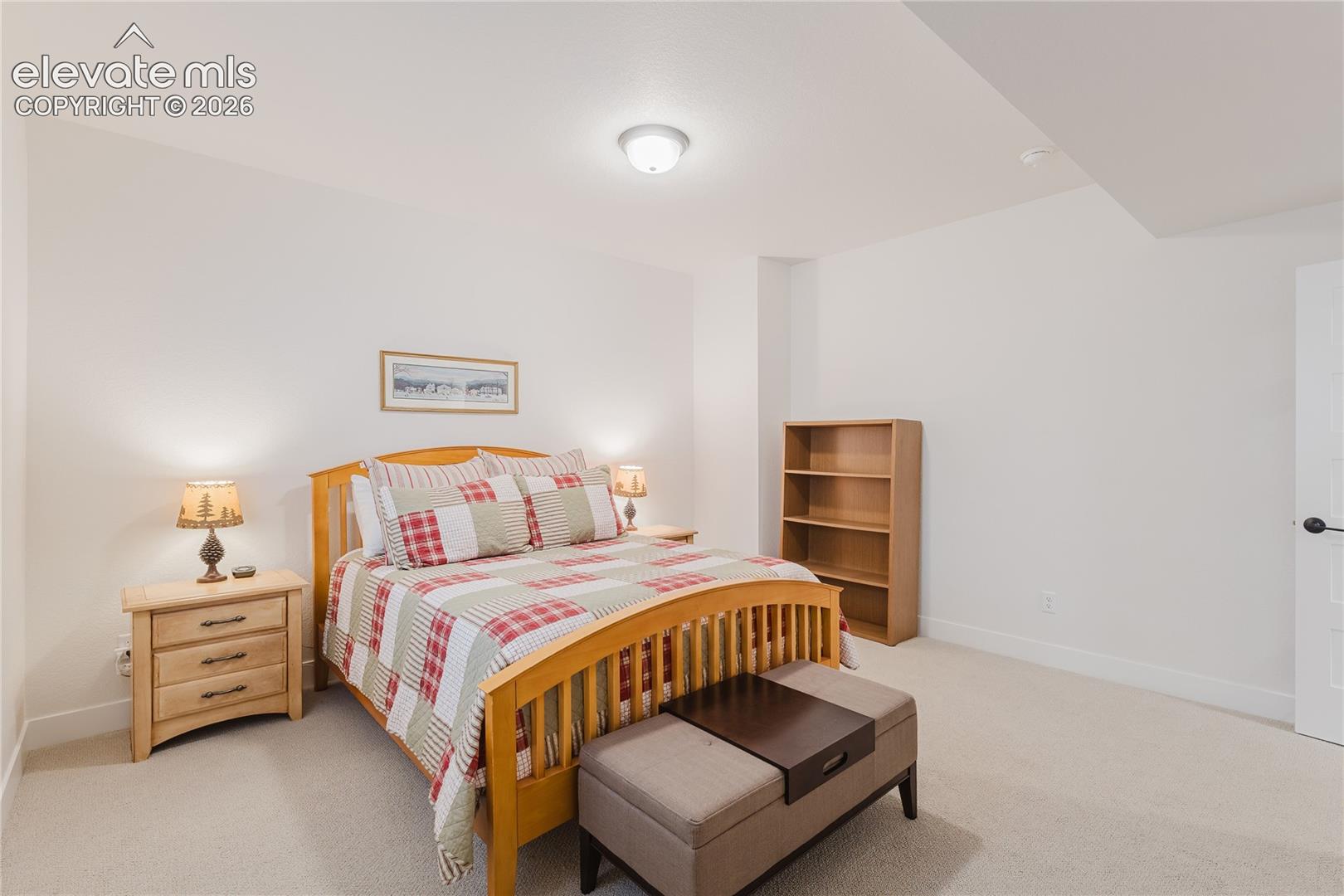 Bedroom in the lower level with plantation shutters and a walk in closet