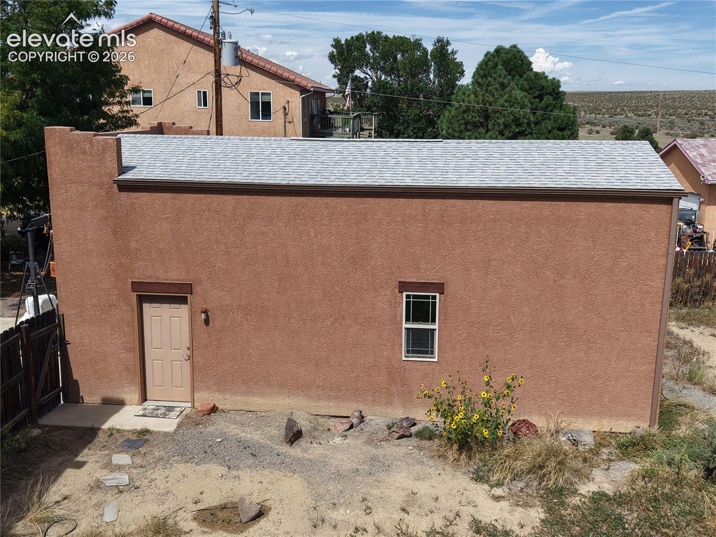 Side of RV Garage, Art studio or Workshop.   Fresh stucco and roof are new.