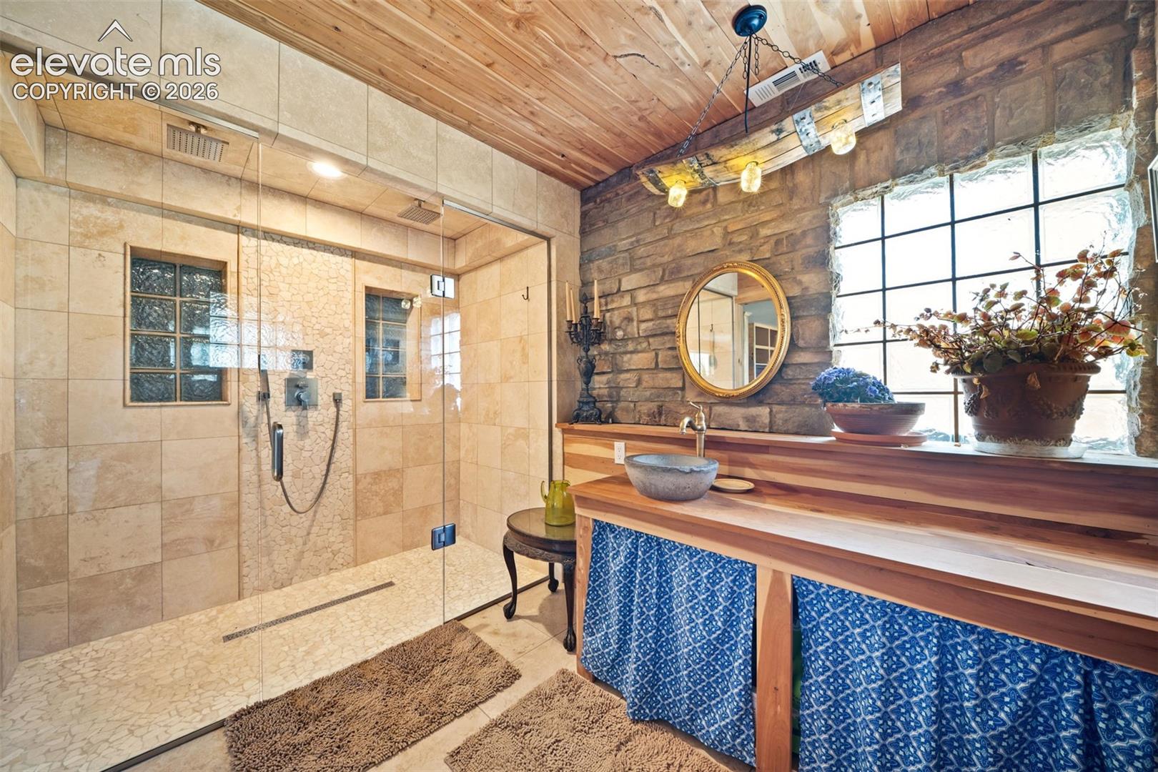 Primary en-suite with a custom tile shower and Delta fixtures.