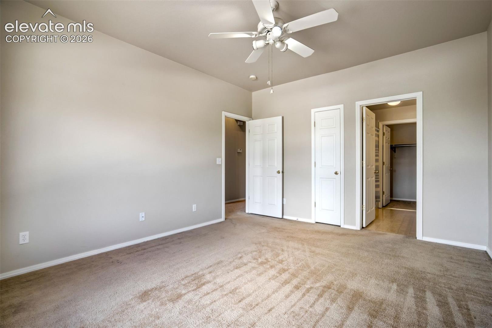 Attached full bathroom with walk-in closet and another closet with shelving