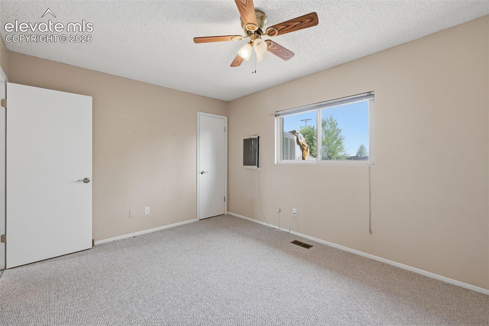 Neutral-toned walls complement the light-colored carpeting