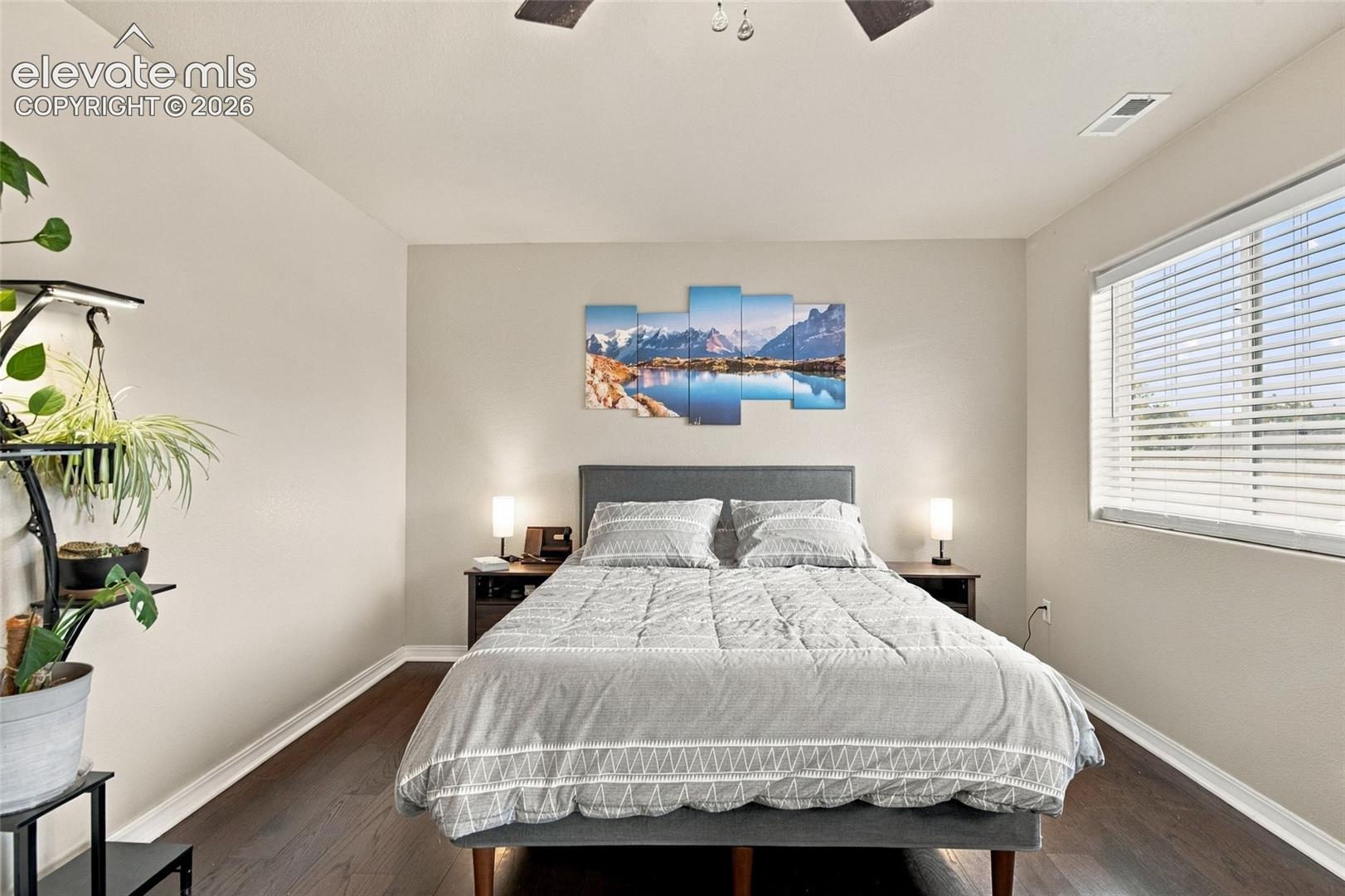 Wood-finish flooring, ceiling fan, and horizontal window blinds