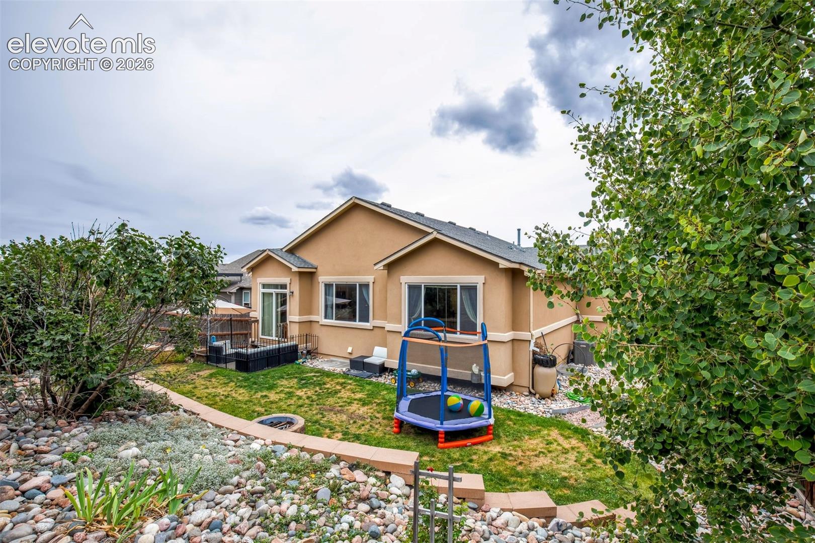 Fully landscaped backyard with built in firepit