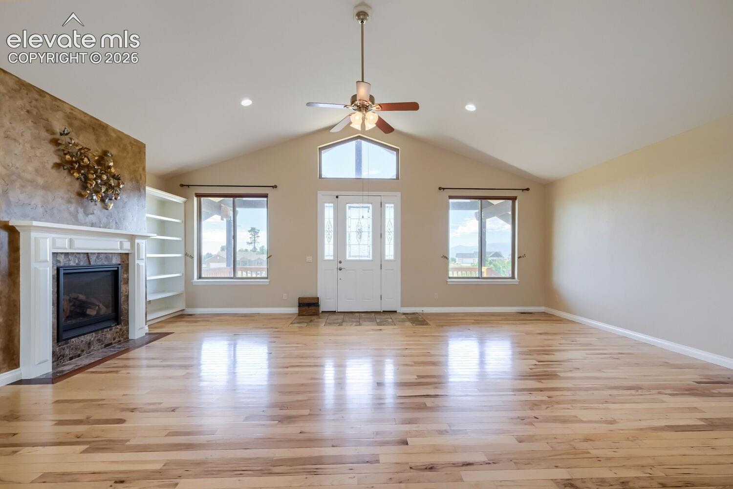 The Greatroom features a gas fireplace and views of Pikes Peak. The following three images show two furniture configurations for this beautiful great room.