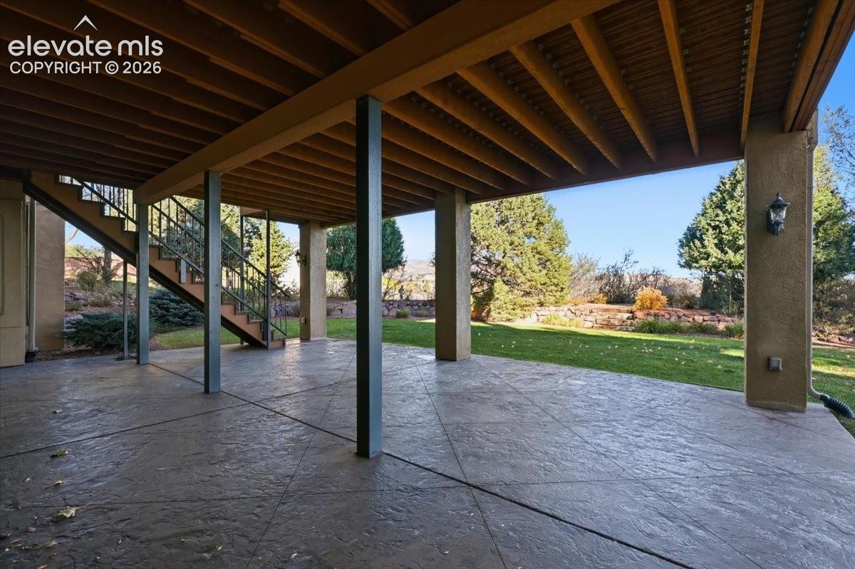 Covered patio accessed through the media/game room and from the deck above. 