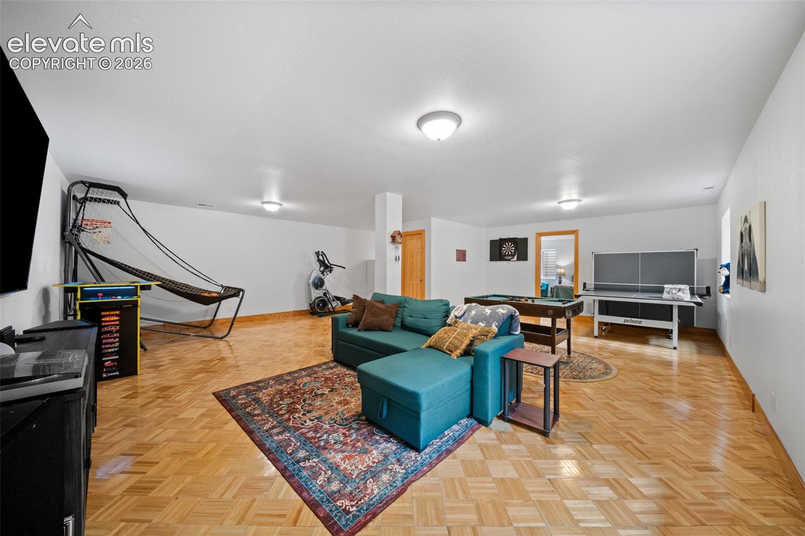 Large family room in the basement that can be used entertaining, game room or workout space