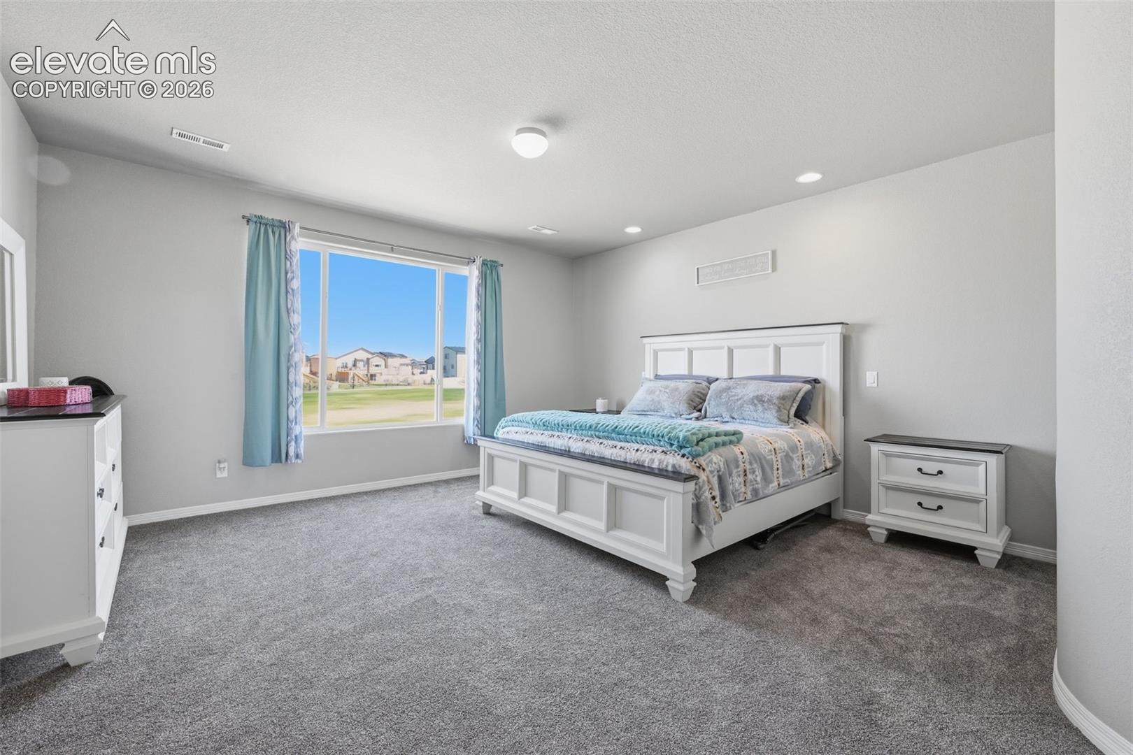 Another View of the Spacious Primary Suite with Open-Space Views Beyond