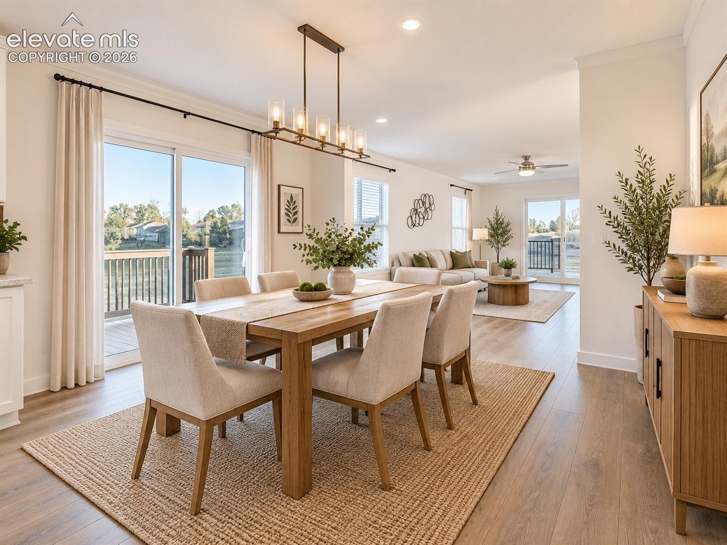Open-concept dining and living spaces create an easy flow for everyday living and entertaining, with abundant windows and access to the outdoor deck.
