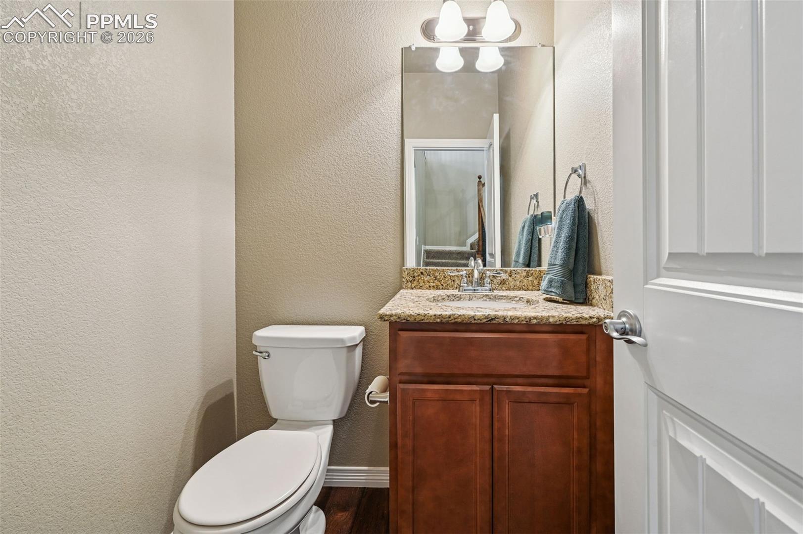 Bathroom featuring vanity and a textured wall