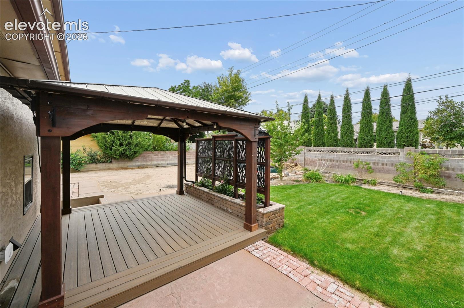 Beautifully Landscaped Backyard with Covered Deck