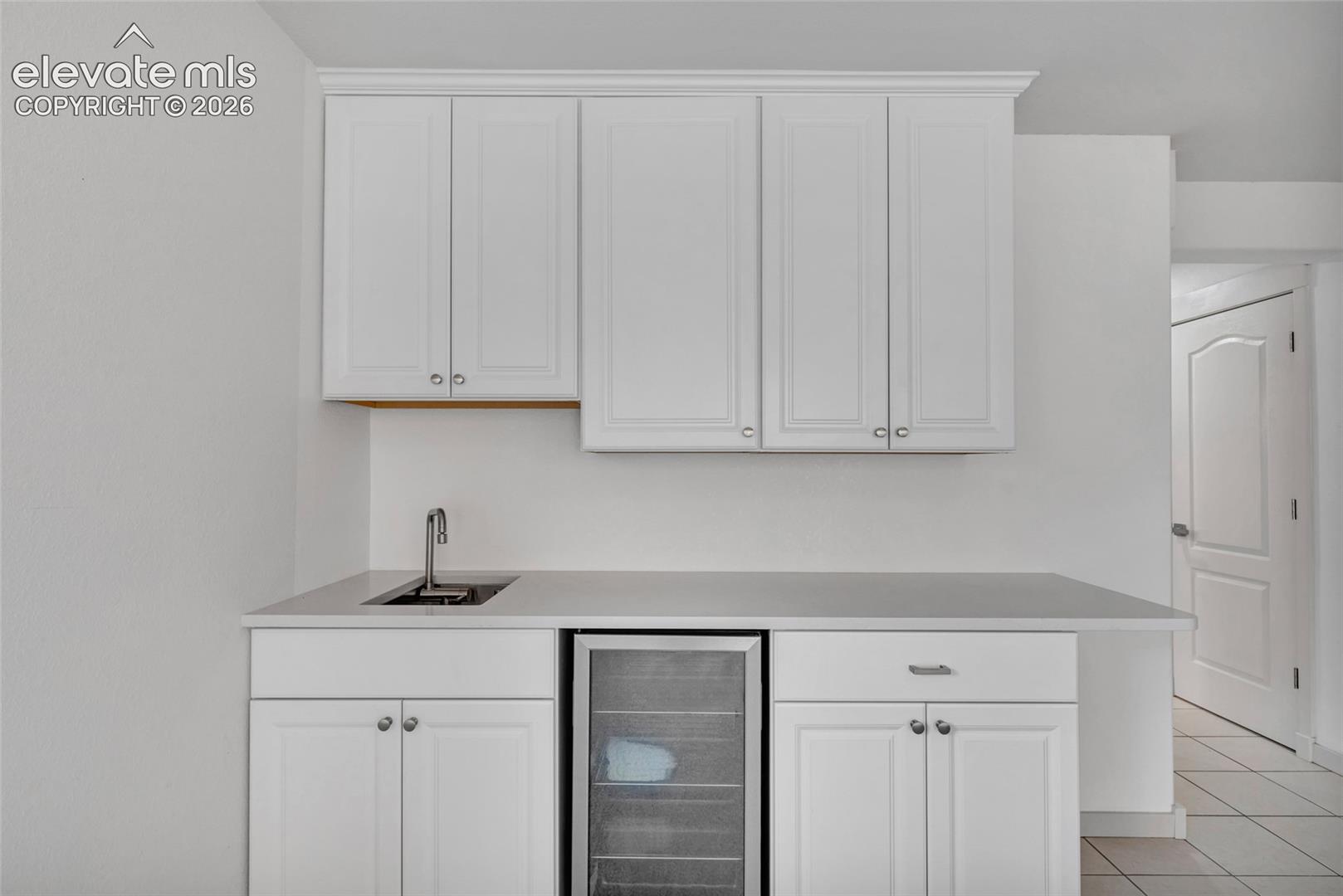 Wet bar w/collapsible faucet in basement rec room