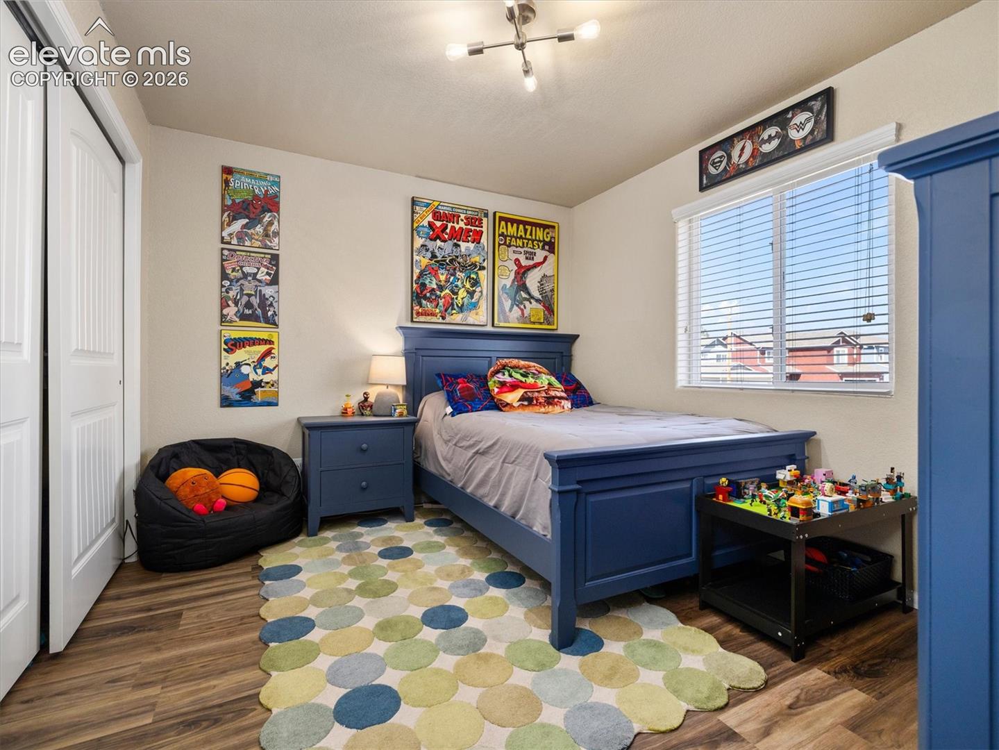 LVP flooring, white bi-fold closet doors, and a window with blinds
