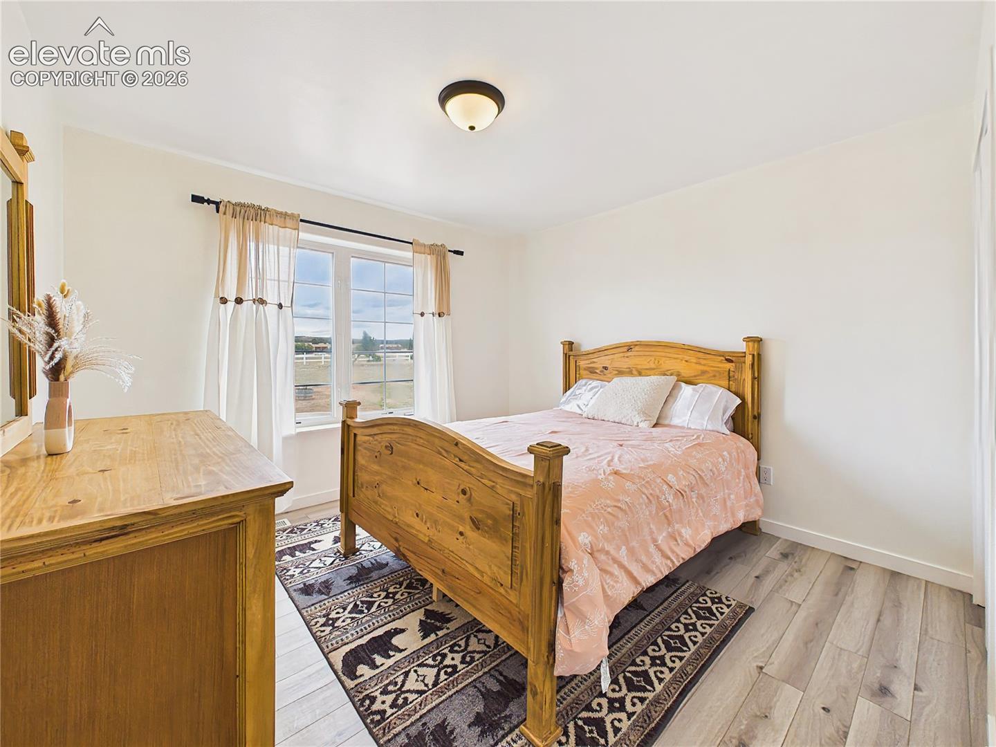Comfortable main level bedroom 2 with ample closet space, updated flooring, and abundant natural light.
